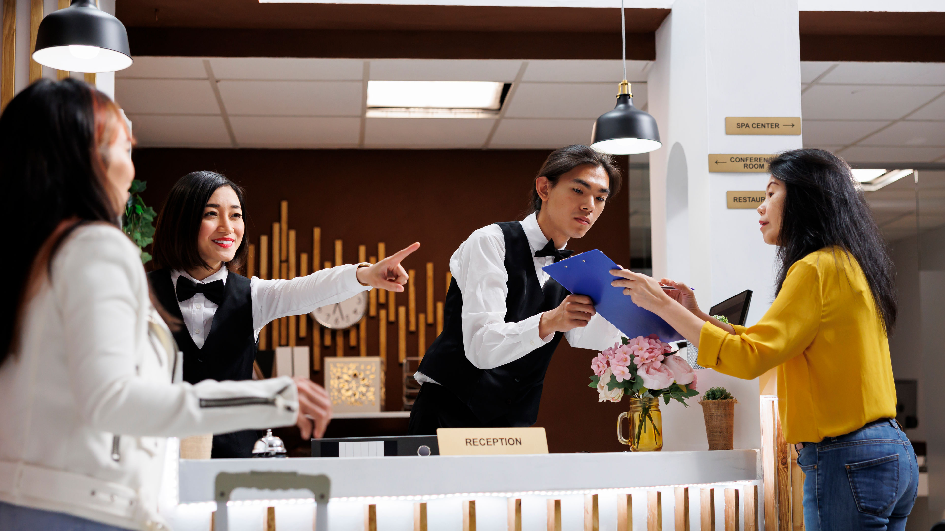 A woman checking into a hotel