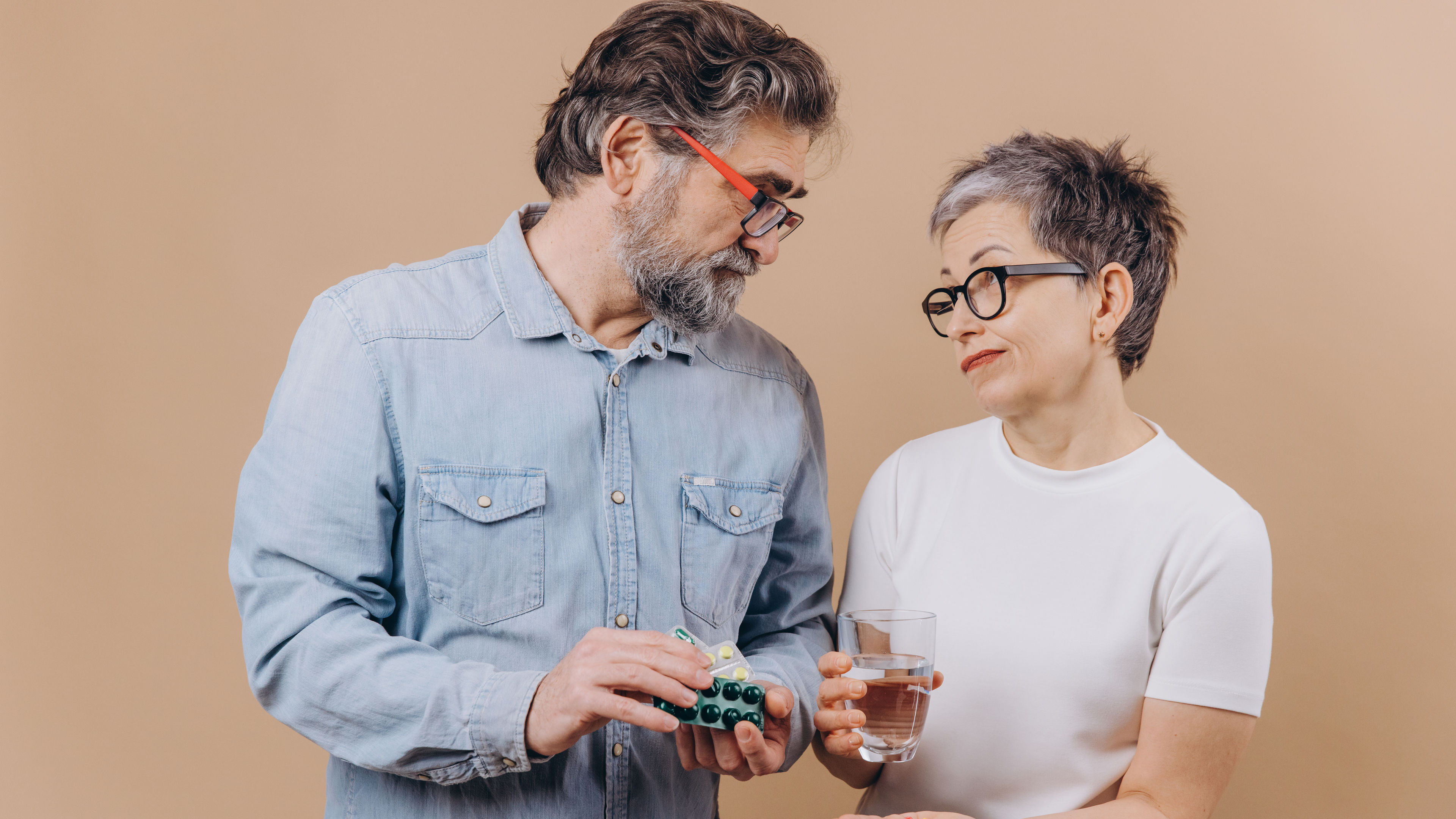 A couple with supplements in hand