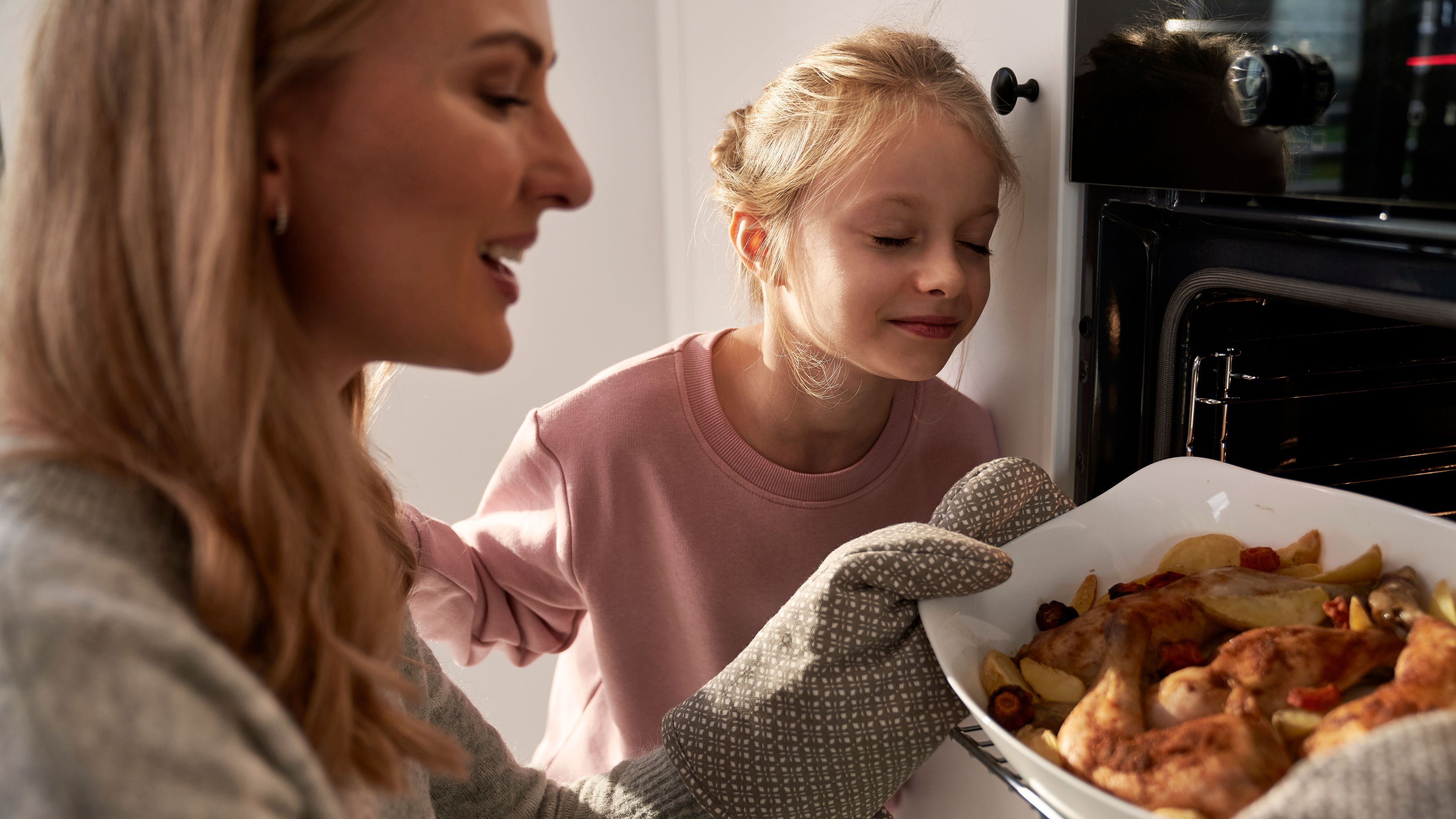 A mother and a daughter preparing some food