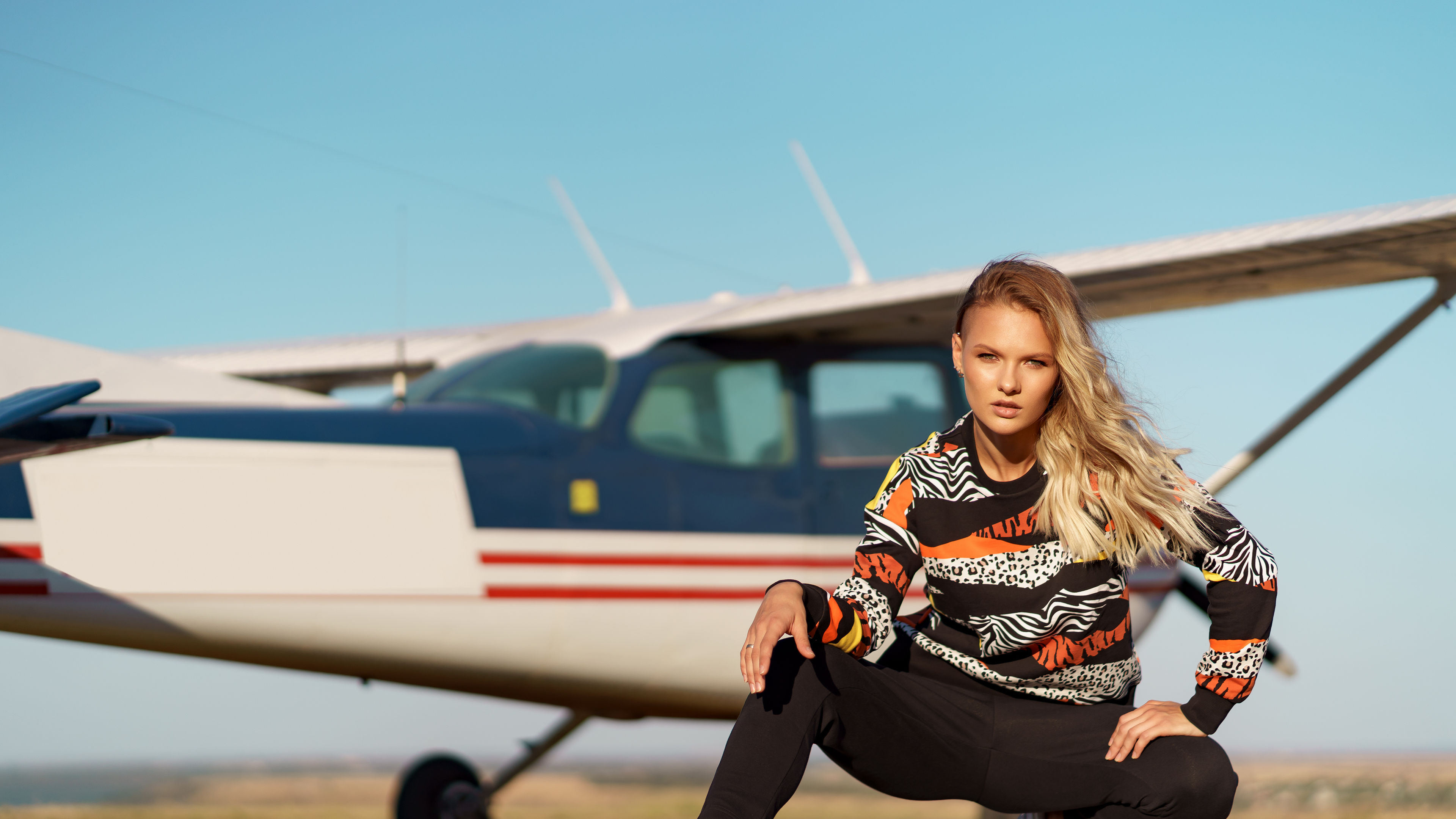 Model posing in a sport outfit and sunglasses. 

