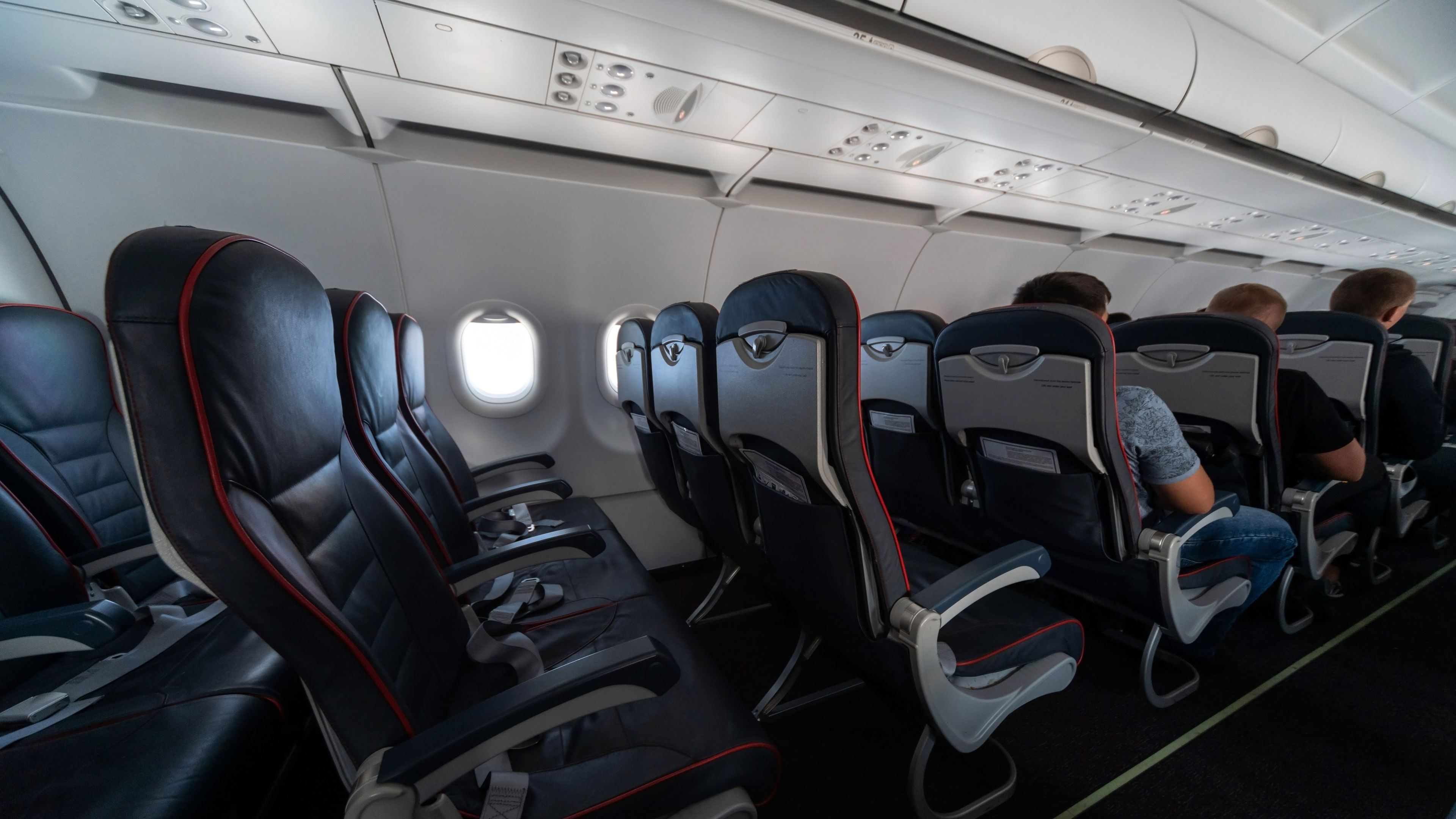 Airplane cabin seats with passengers