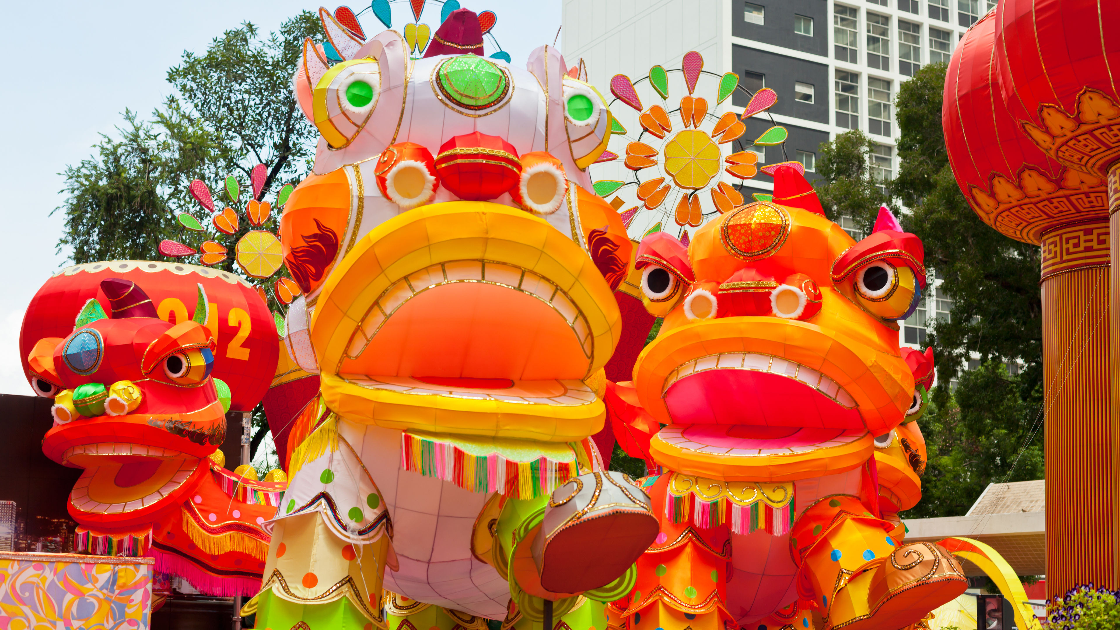 Giant, colorful dragon decorations in a park setting 