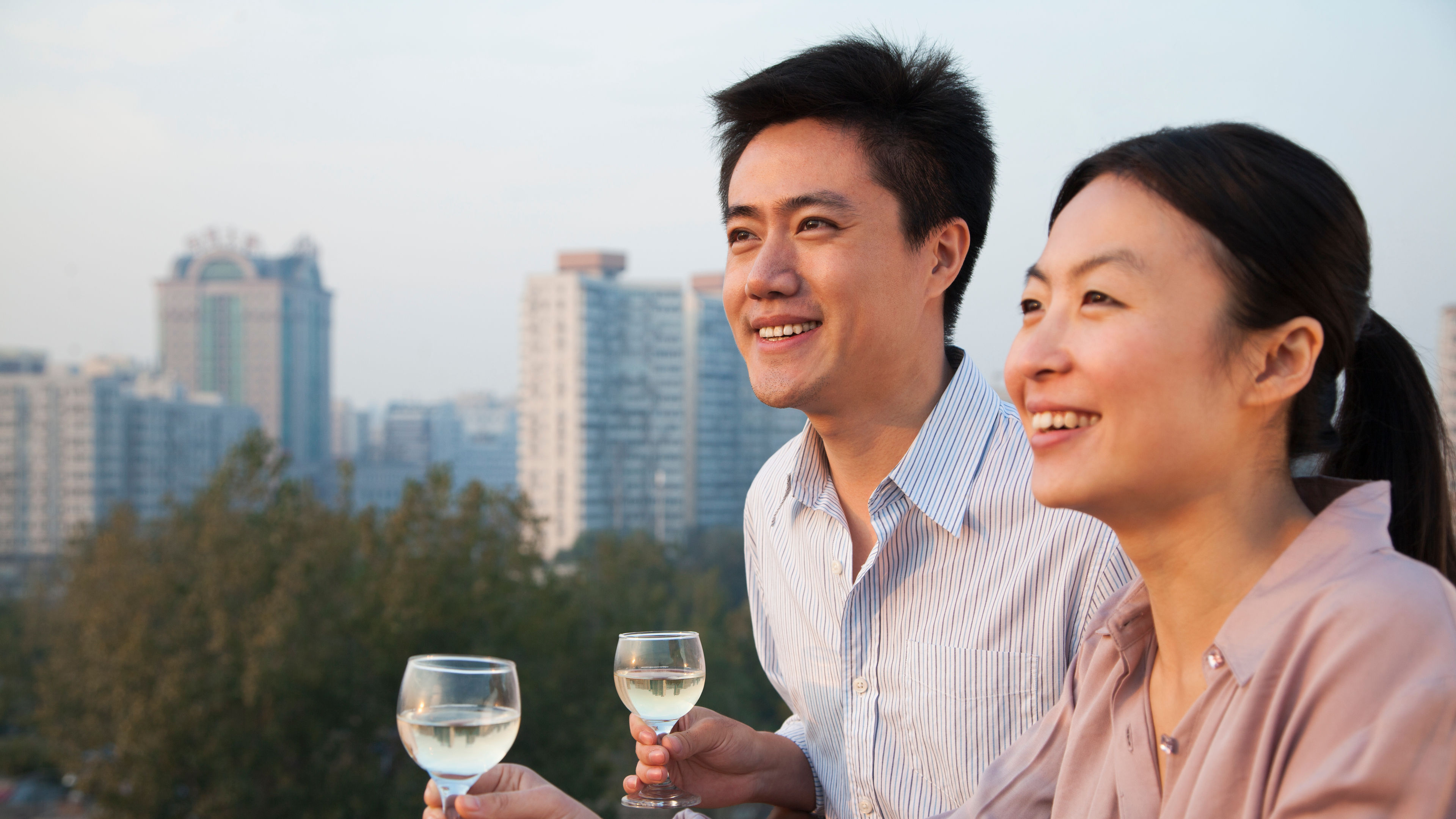 Couple Looking Out Over Cityscape 
