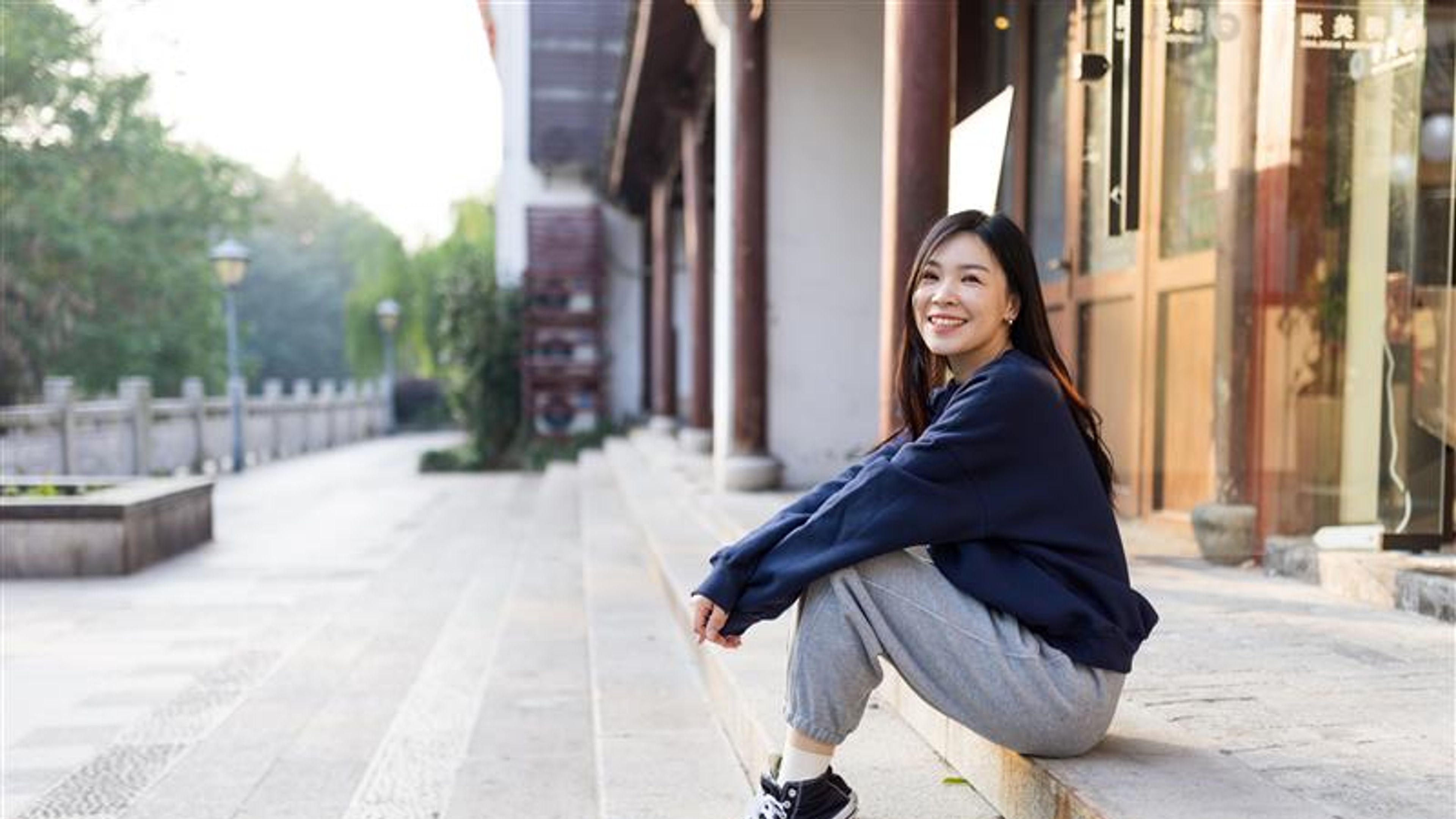 Lifestyle photography of Stylish millennial or gen z girl with brunette hair wearing trendy fashionable joggers