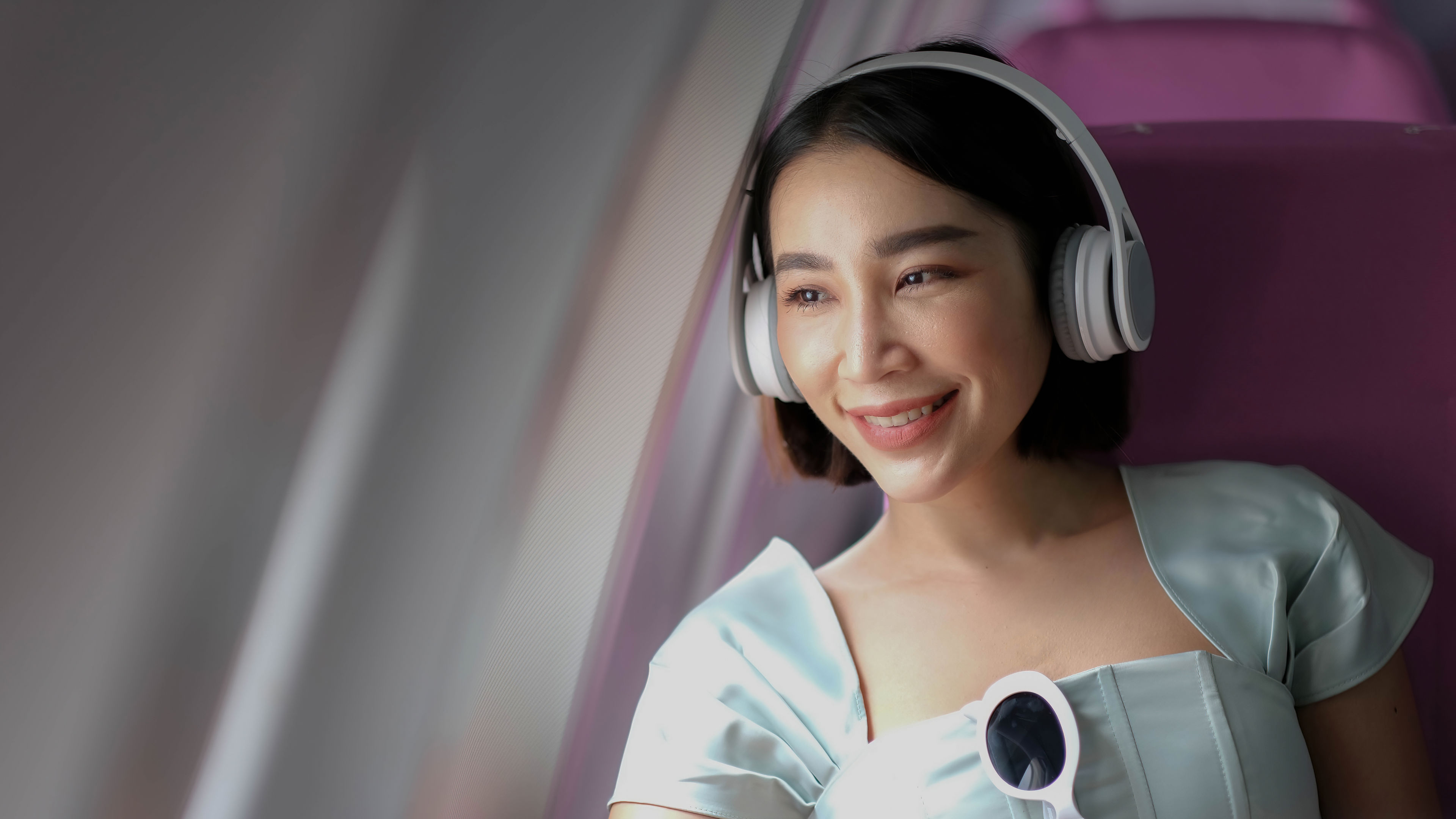 portrait of A successful asian business woman in a plane sits in a business class seat