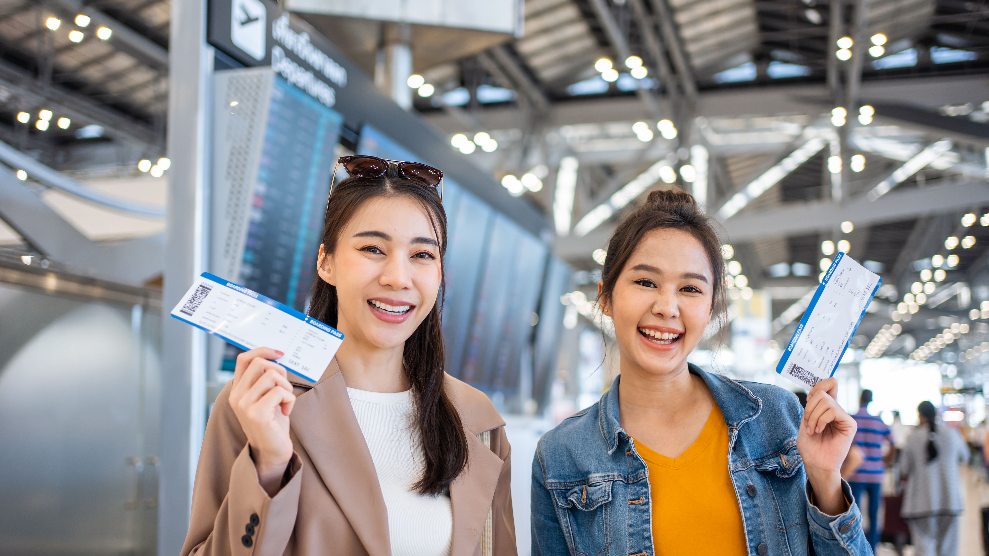 Portrait of Asian women standing in airport terminal at boarding gate