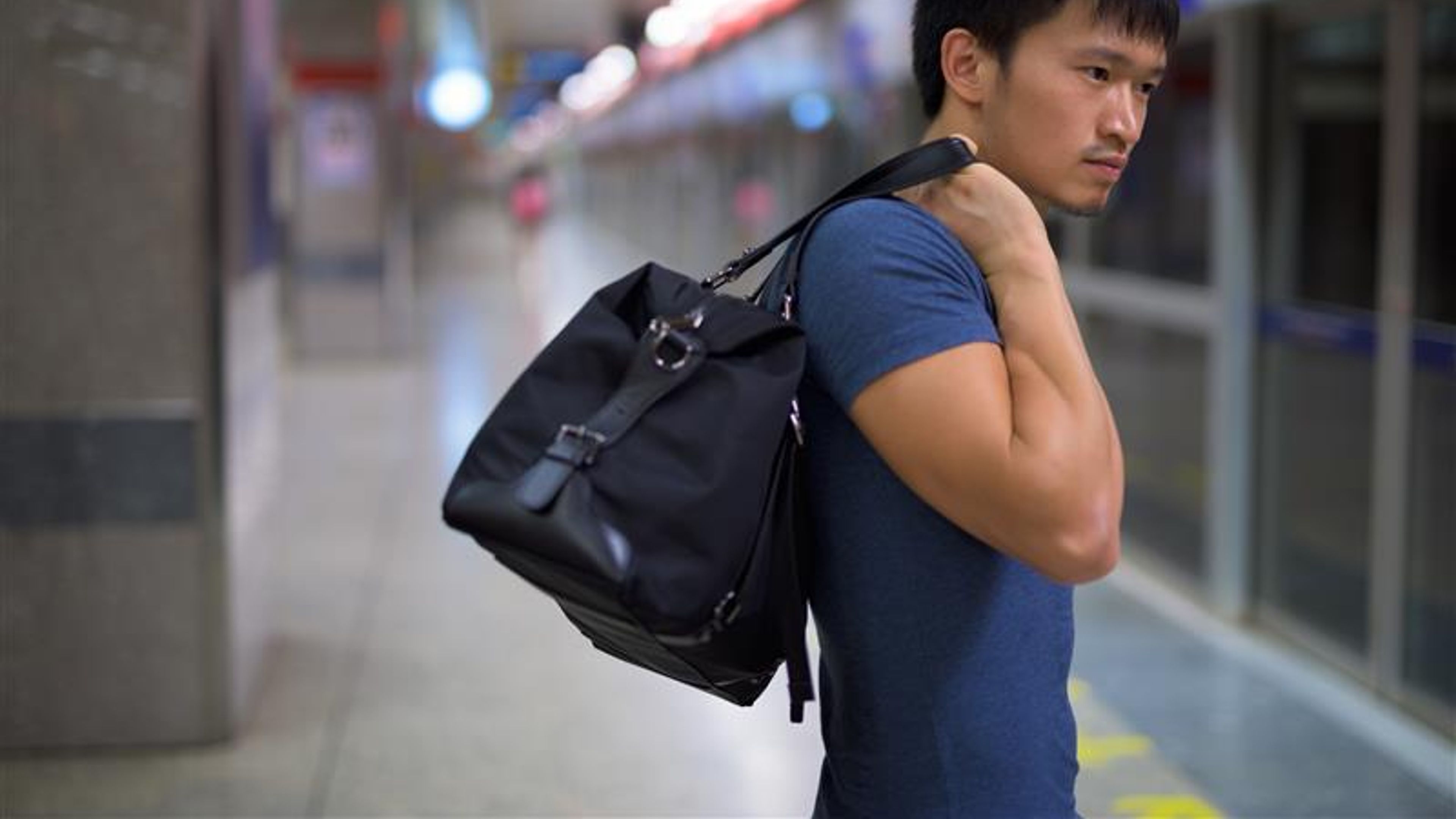 Portrait of young Chinese man at the subway station in the city 