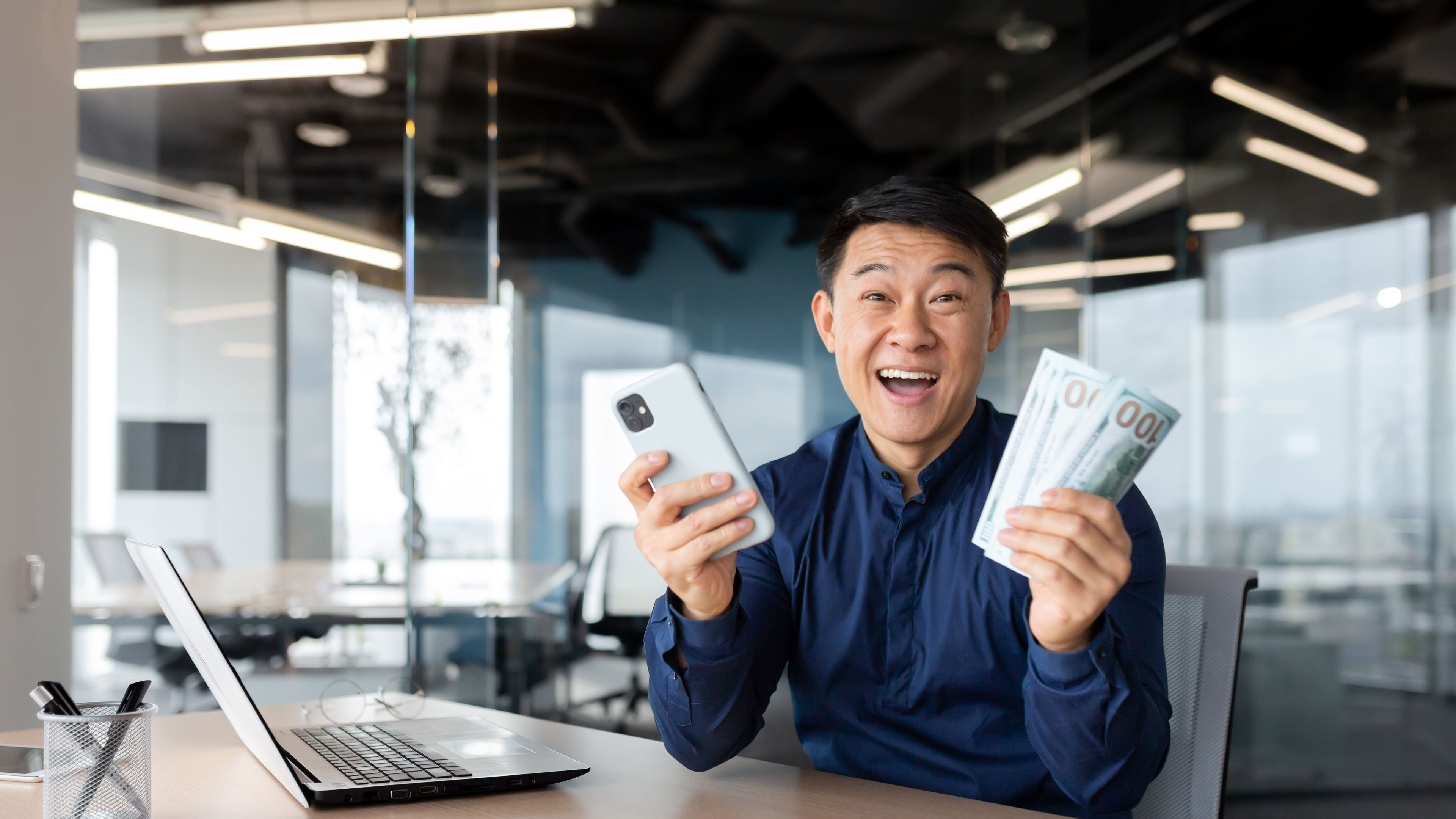 Portrait successful businessman asian smiling contentedly and looking at camera.