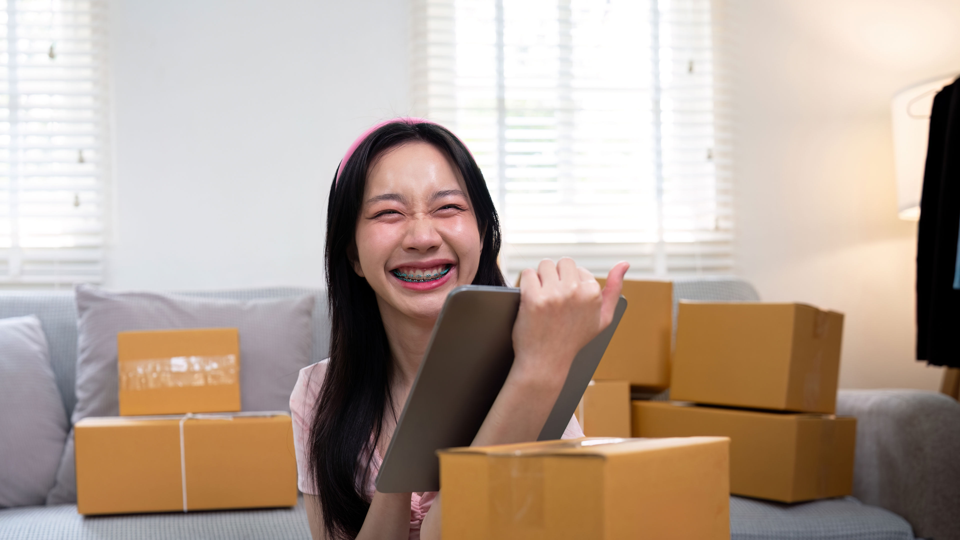 Woman asian in an online store check the customer address and package information on the laptop. 
