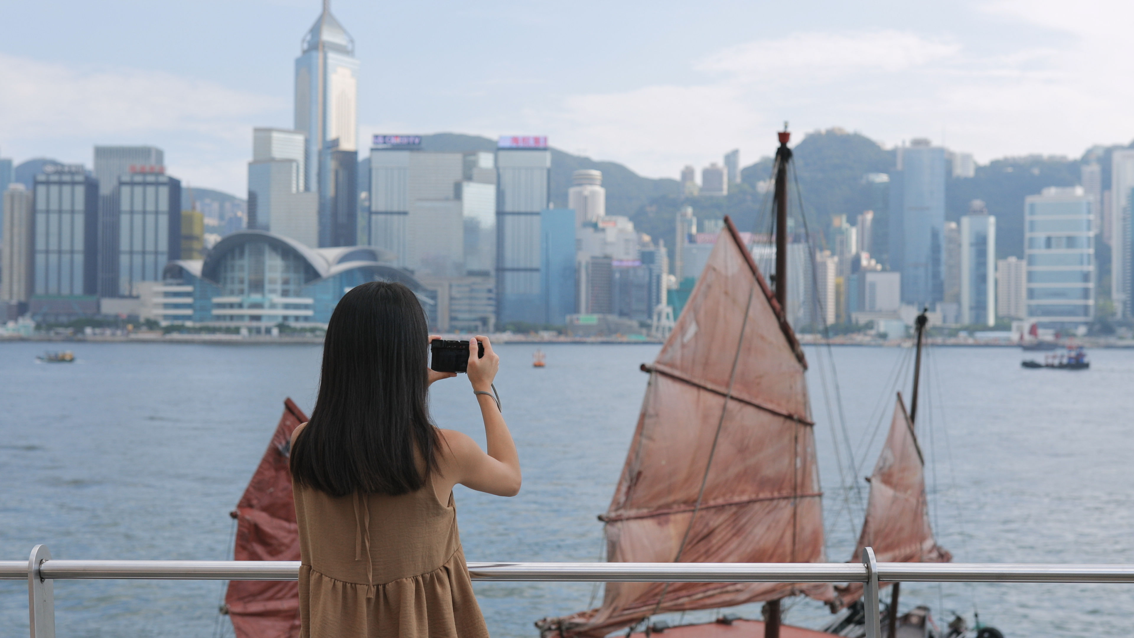 Woman taking photo in Victoria harbor 