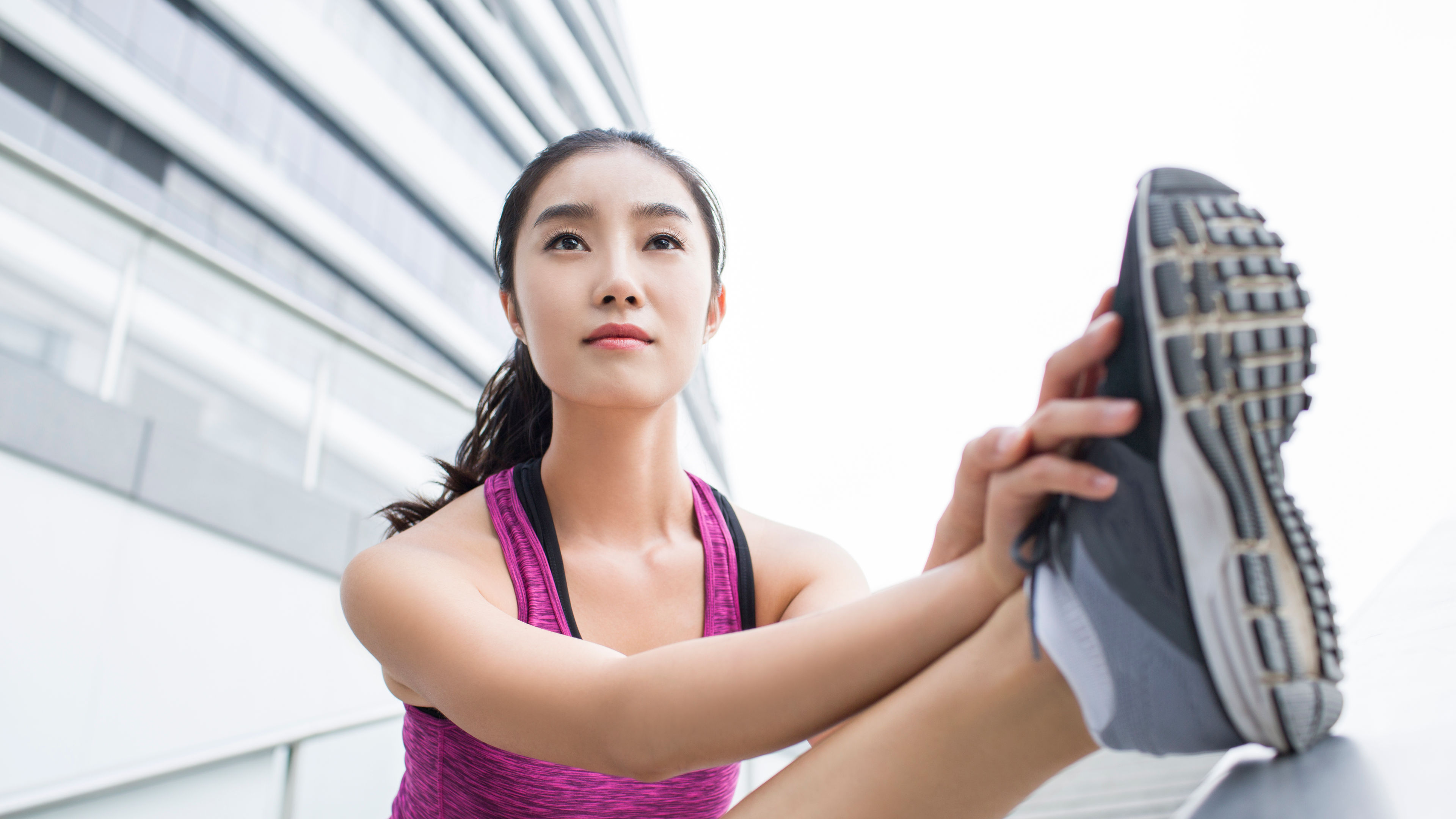 Young women stretching and showing her shoe sole