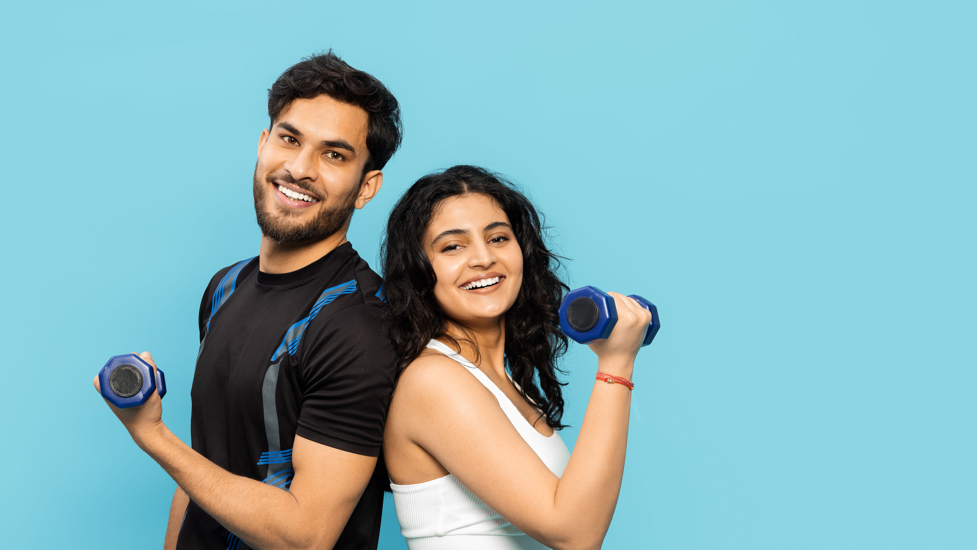 A couple holding dumbbells