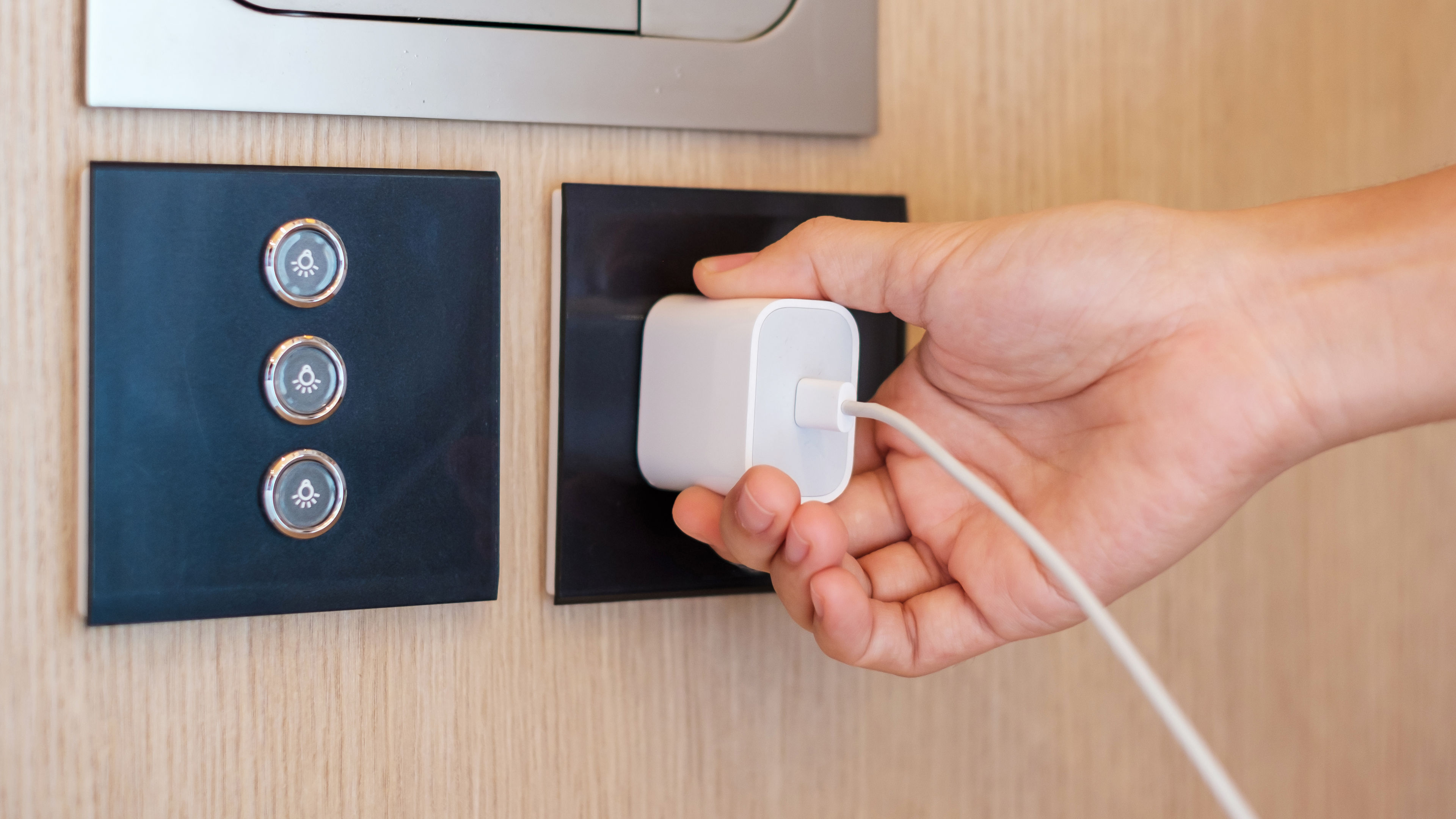 Closeup finger unplugging or plugging of electricity device at home