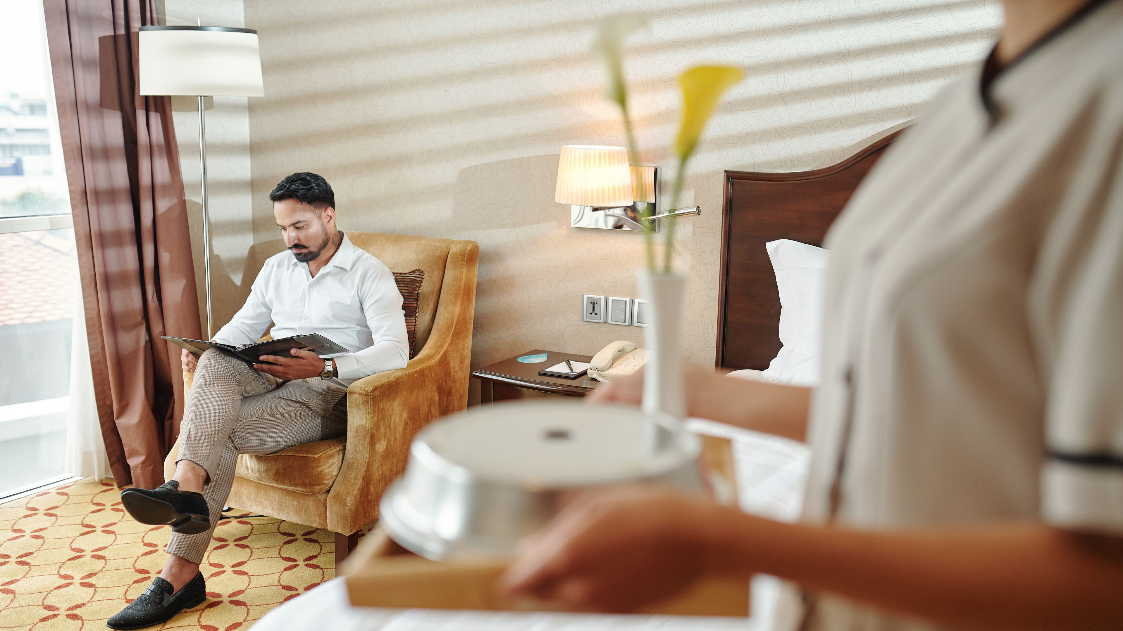 Man reading in hotel room