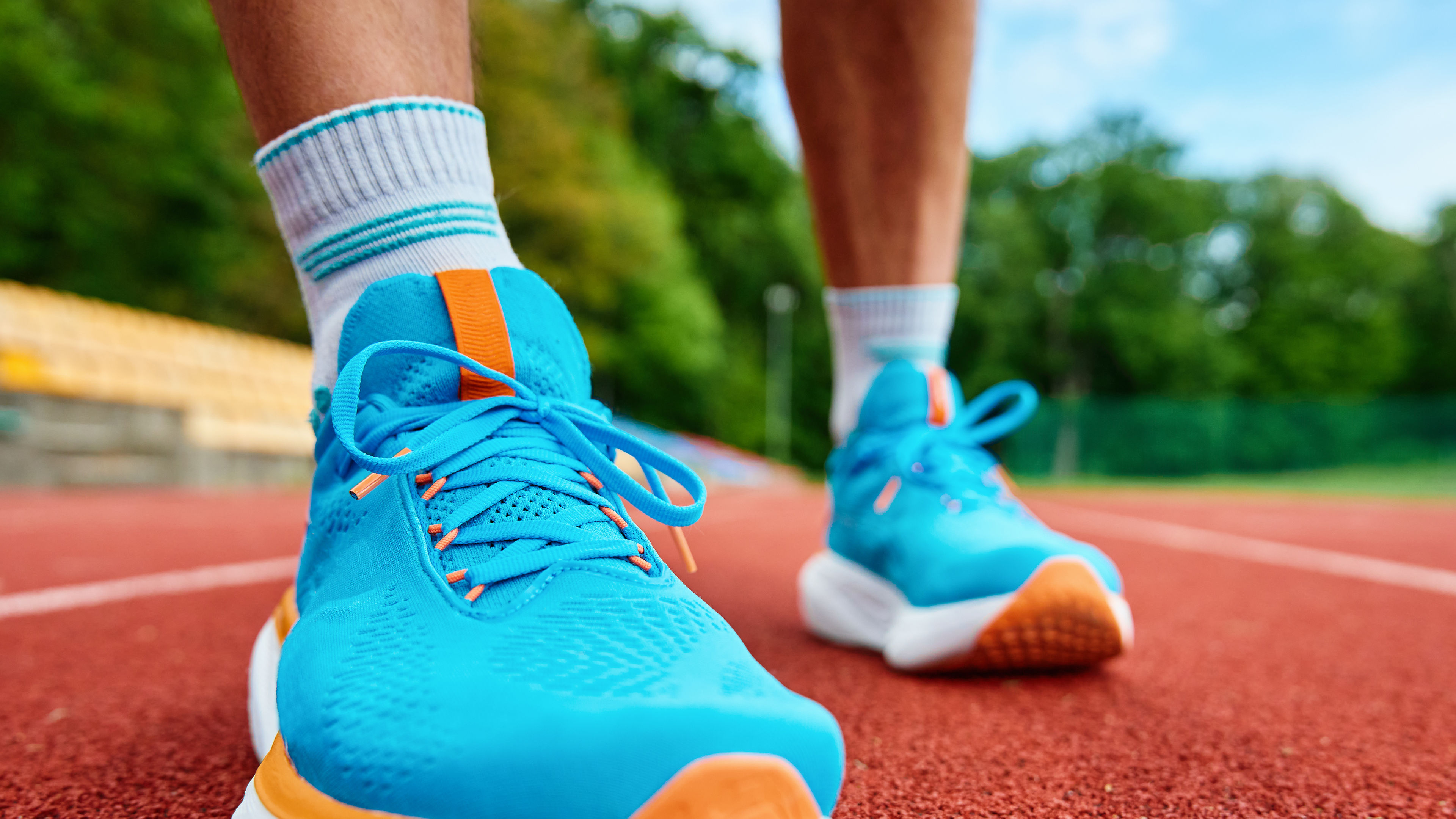 Runner feet running at sport stadium track