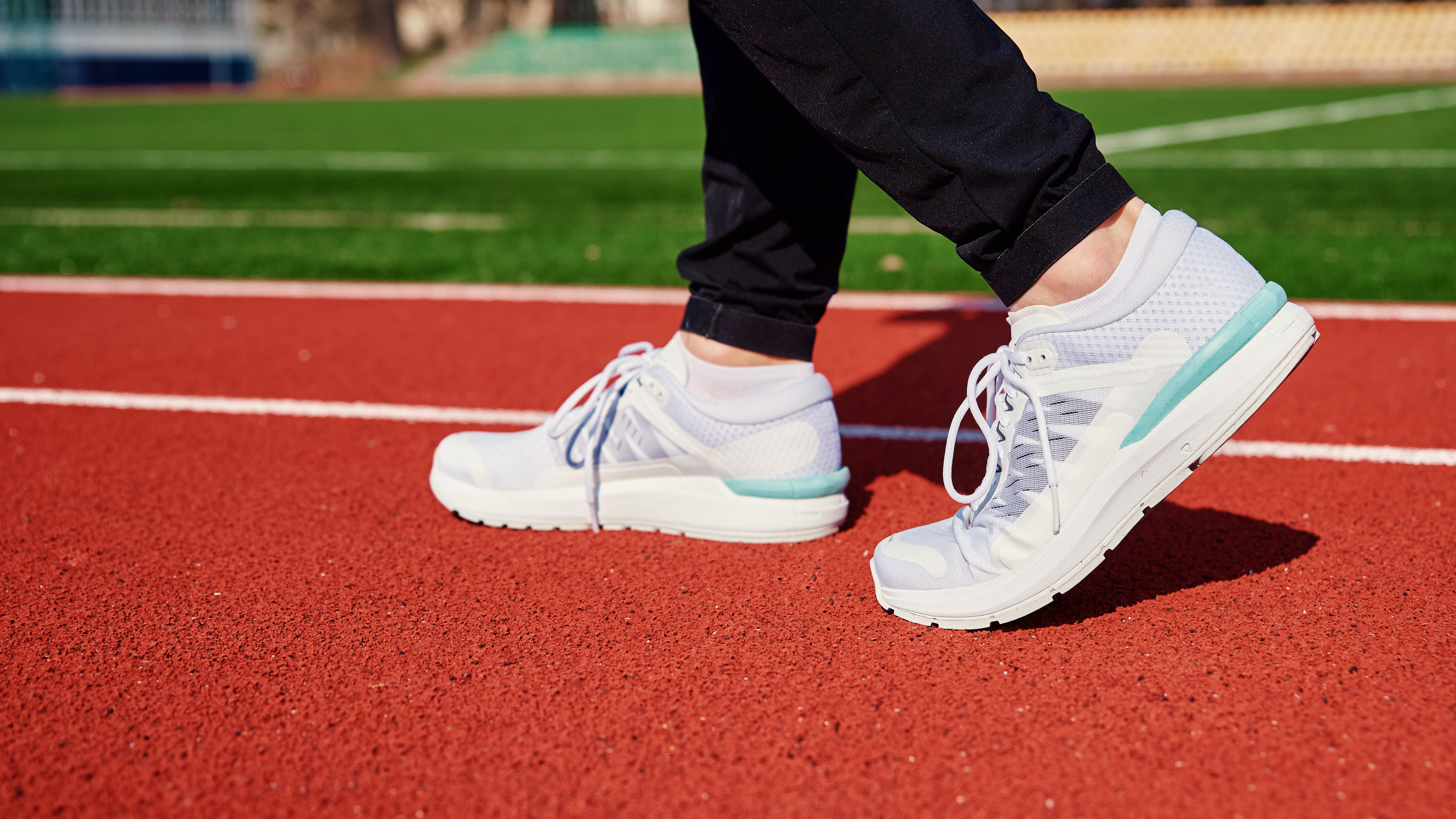 Running Shoes on Red Stadium Track During Training