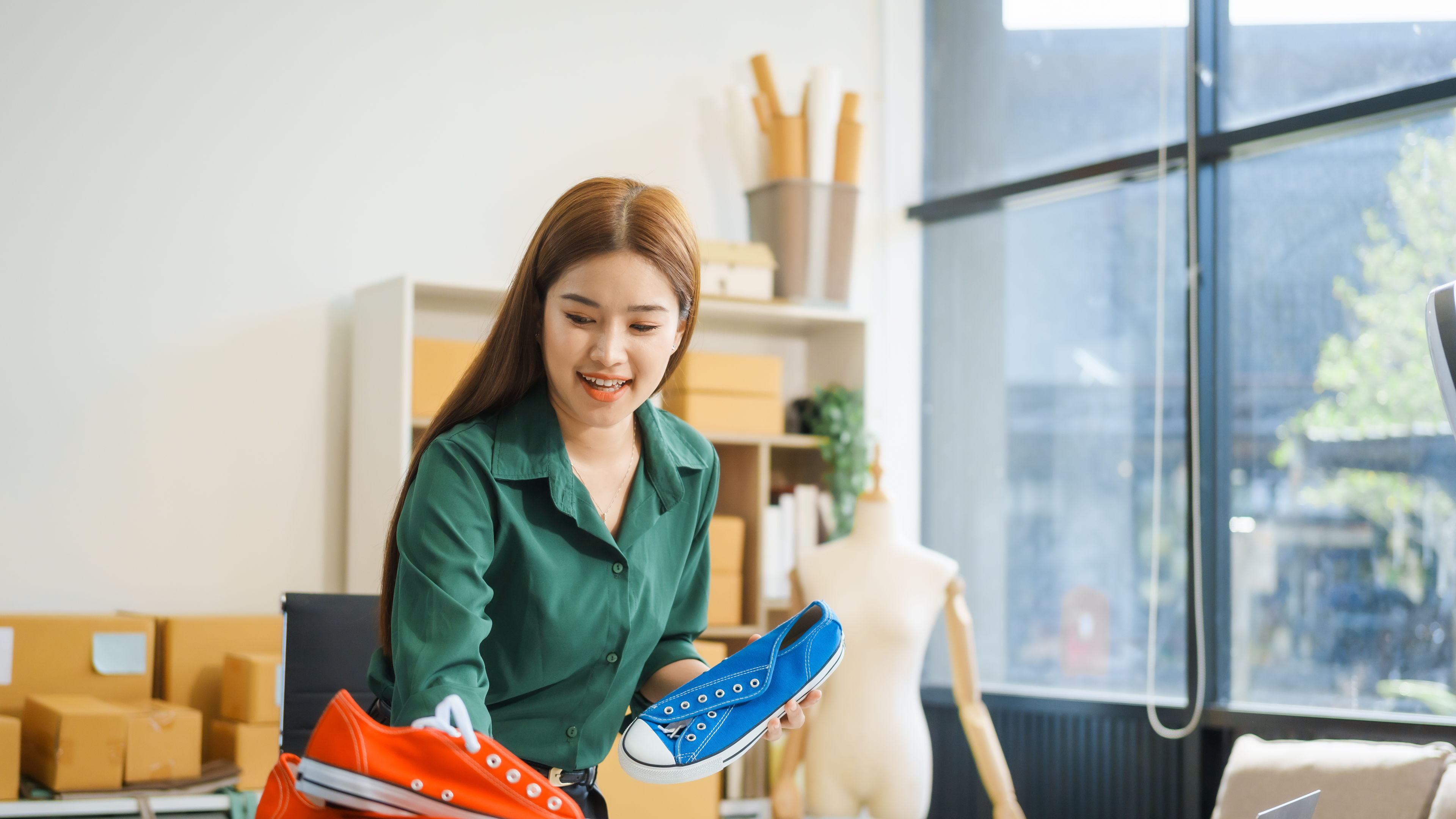 Excited woman checks out trendy sneakers
