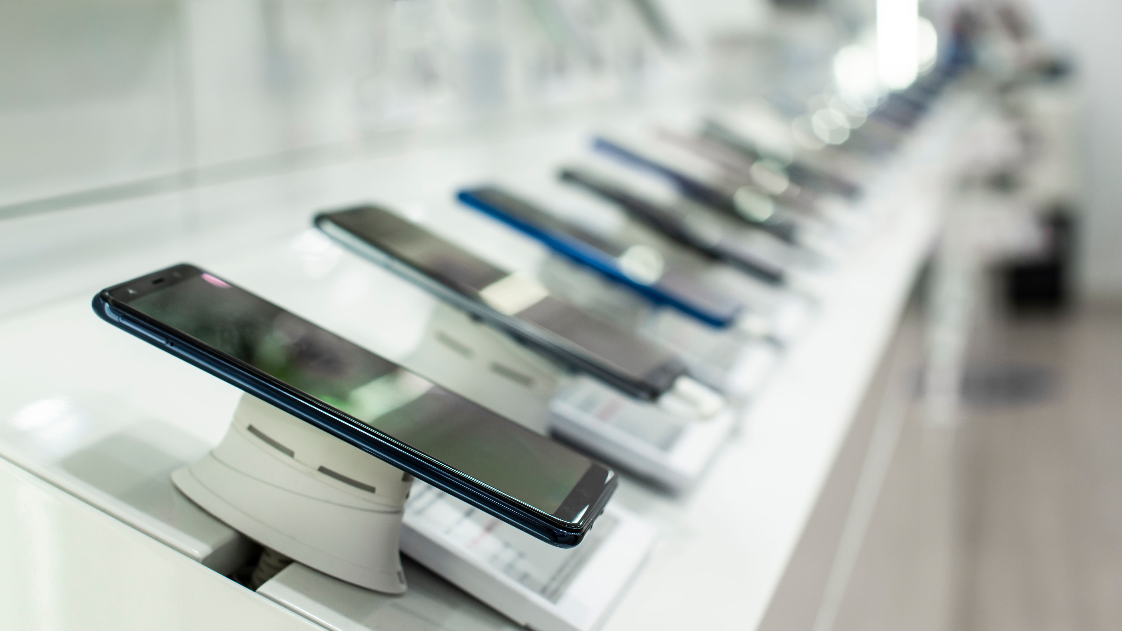 A row of different smartphones in a shop 