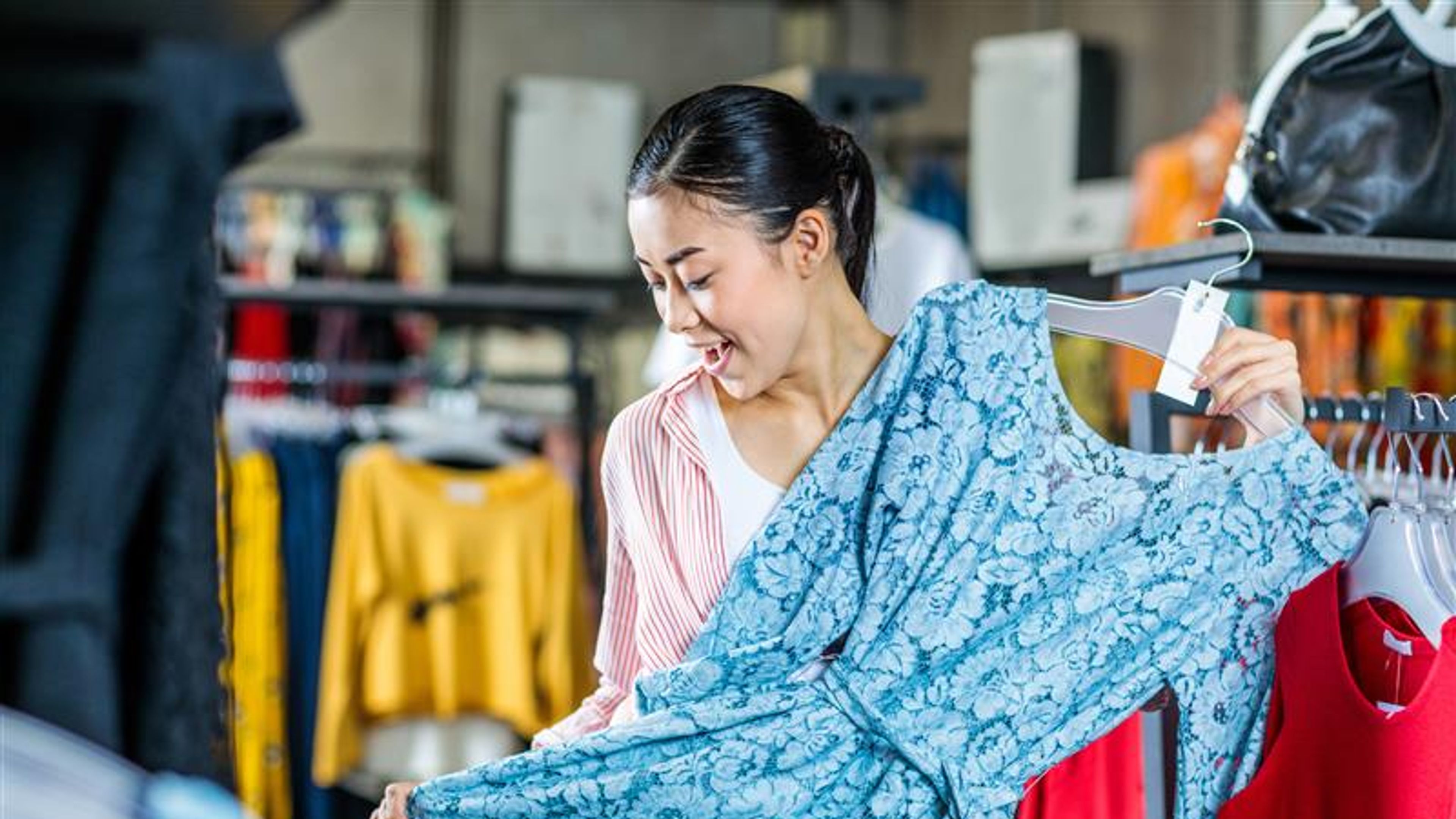 asian hipster girl choosing clothes in shopping mall, boutique shopping concept