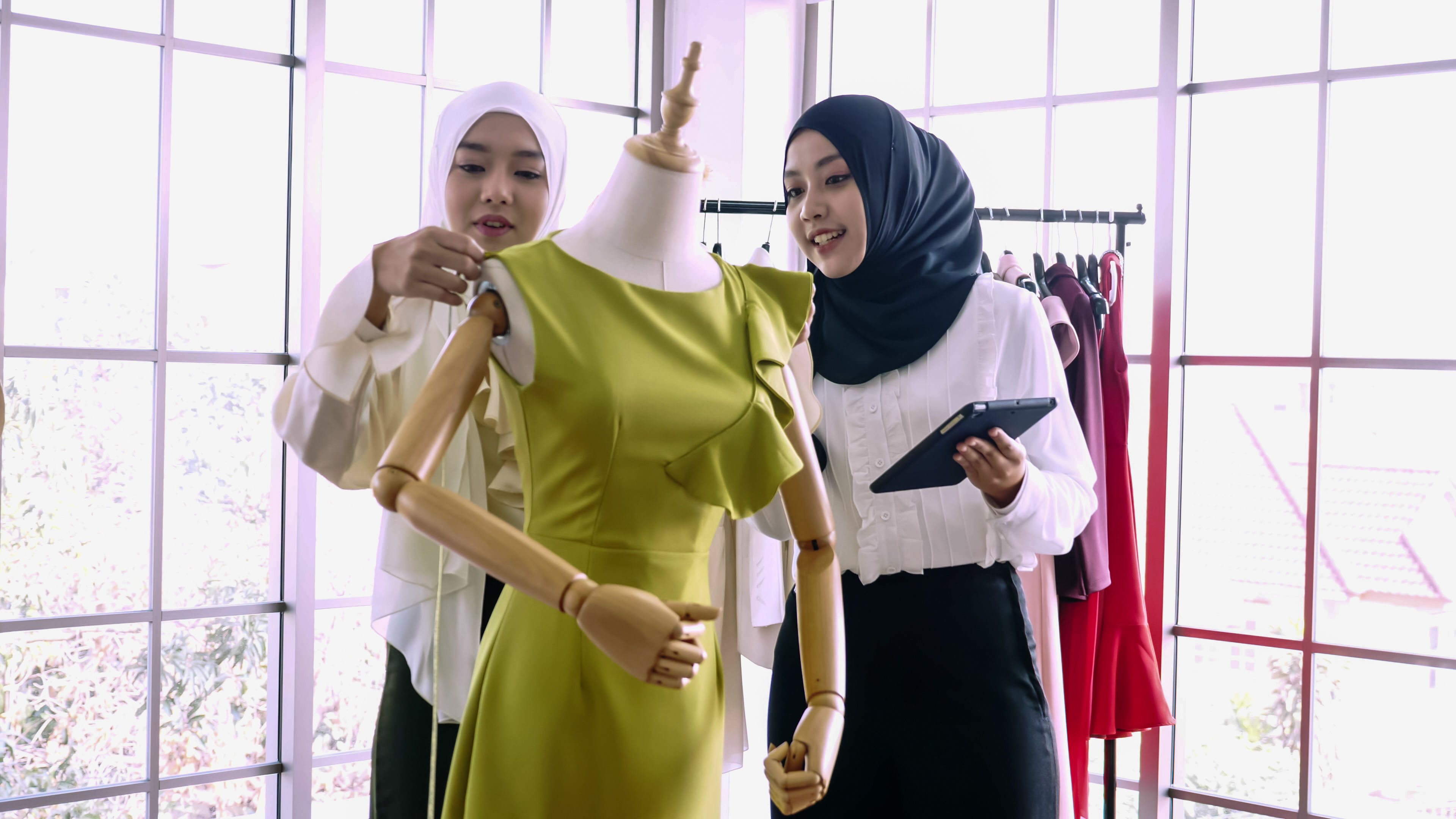 Beautiful muslim women working together at the clothing office