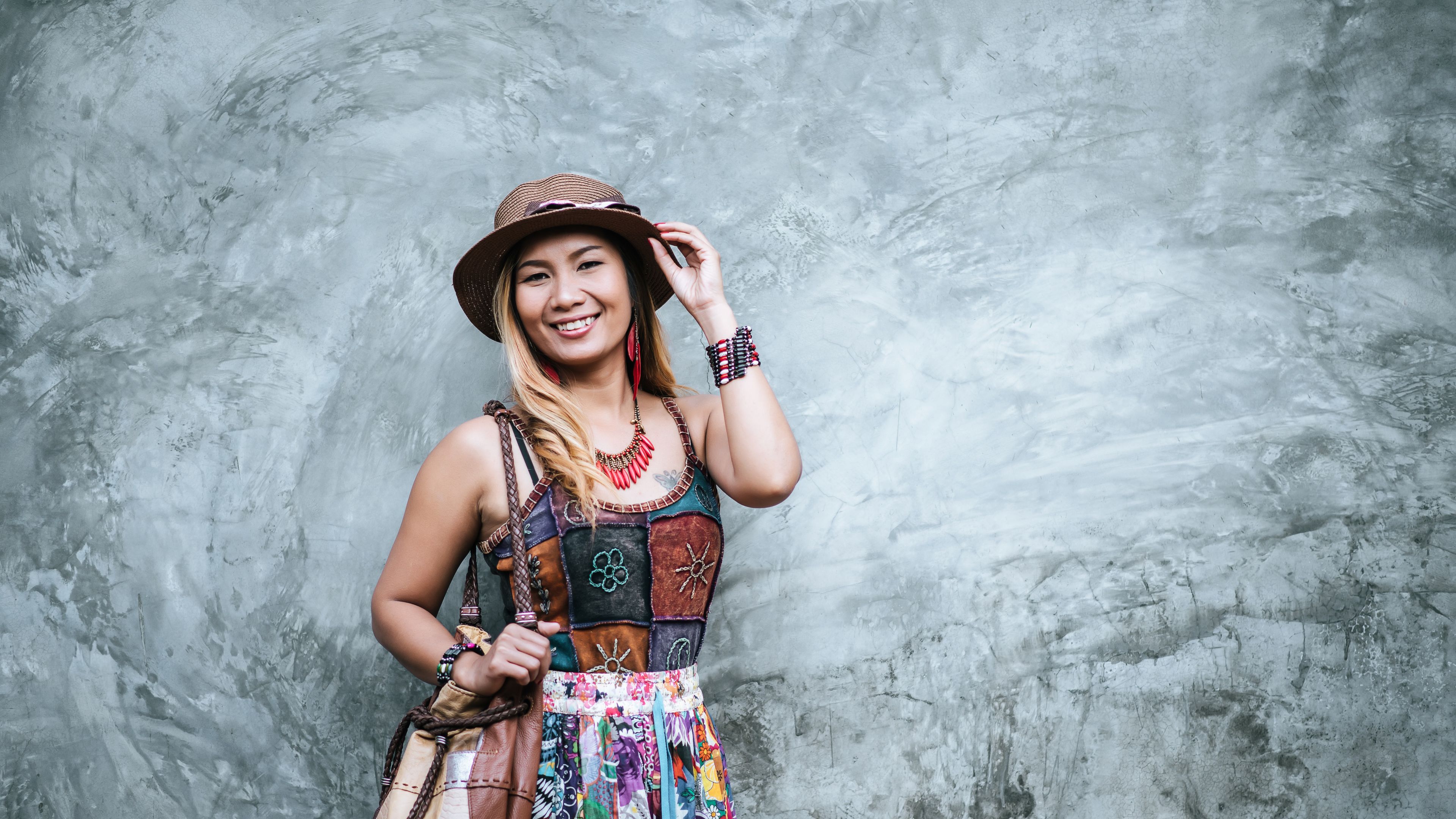 Happy woman, positive and beautiful blonde, posing over a white wall 