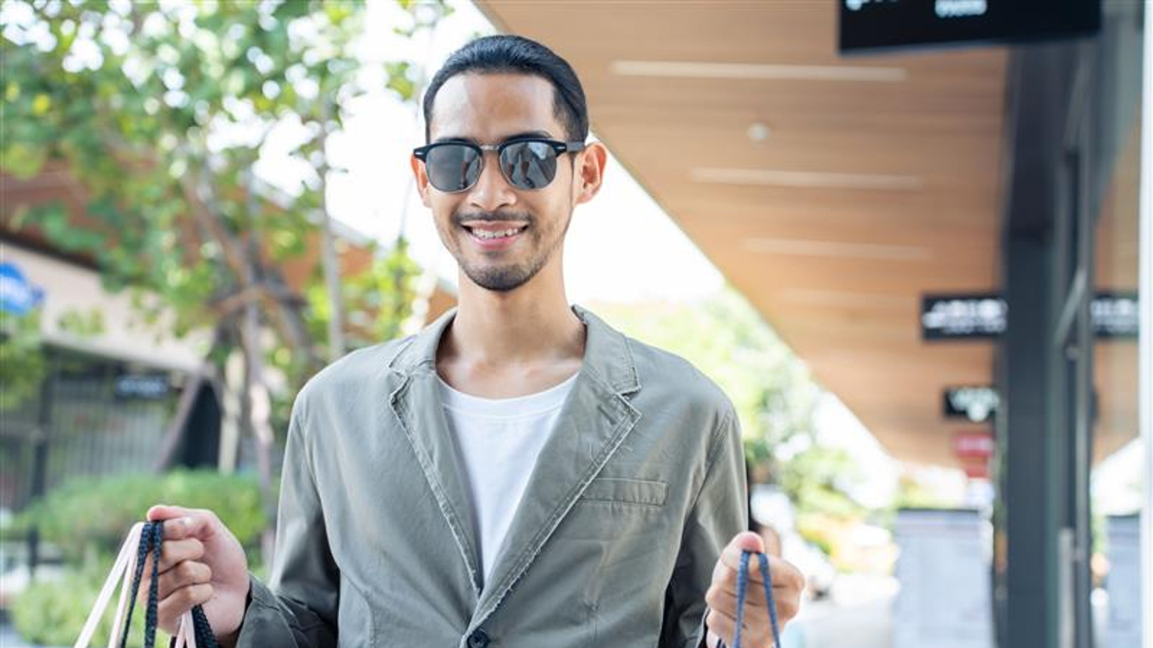 Portrait of Asian handsome male shopping outdoor in department store