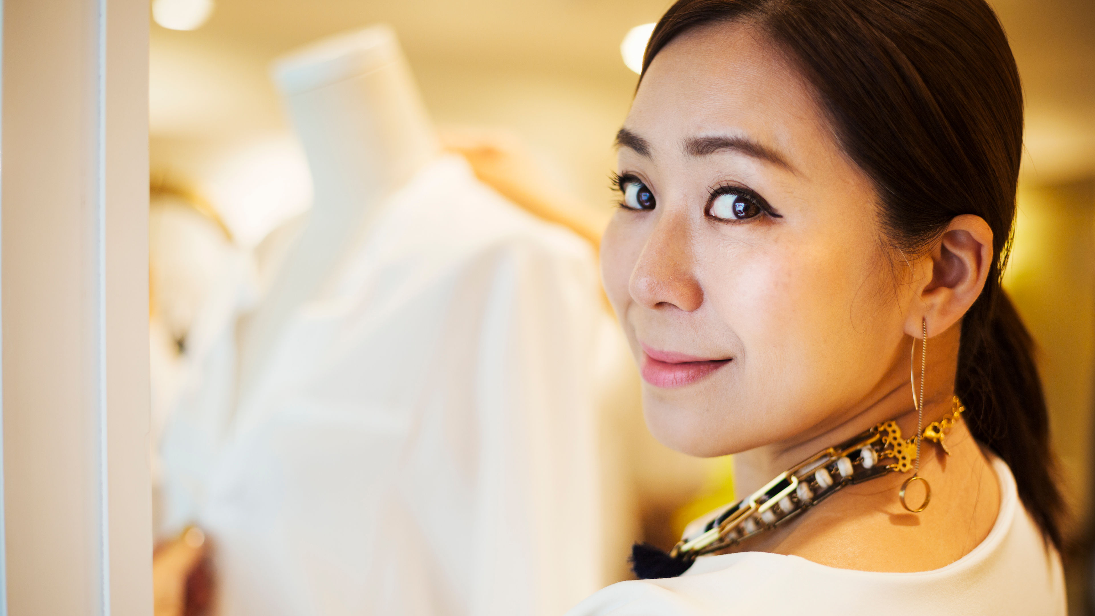 A woman managing her duties in a stylish fashion boutique in Asia. 