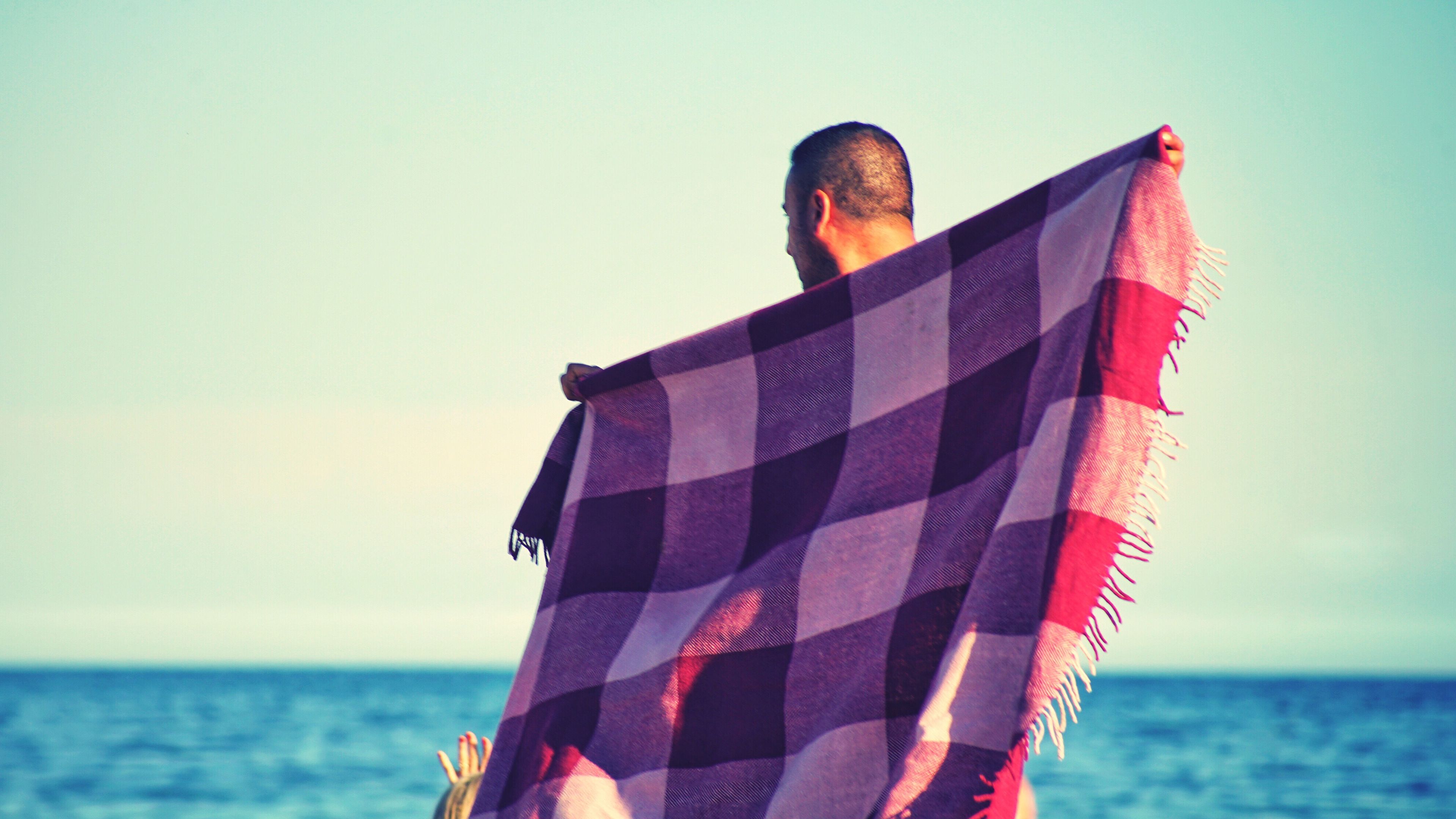 A man with a beach towel in hand