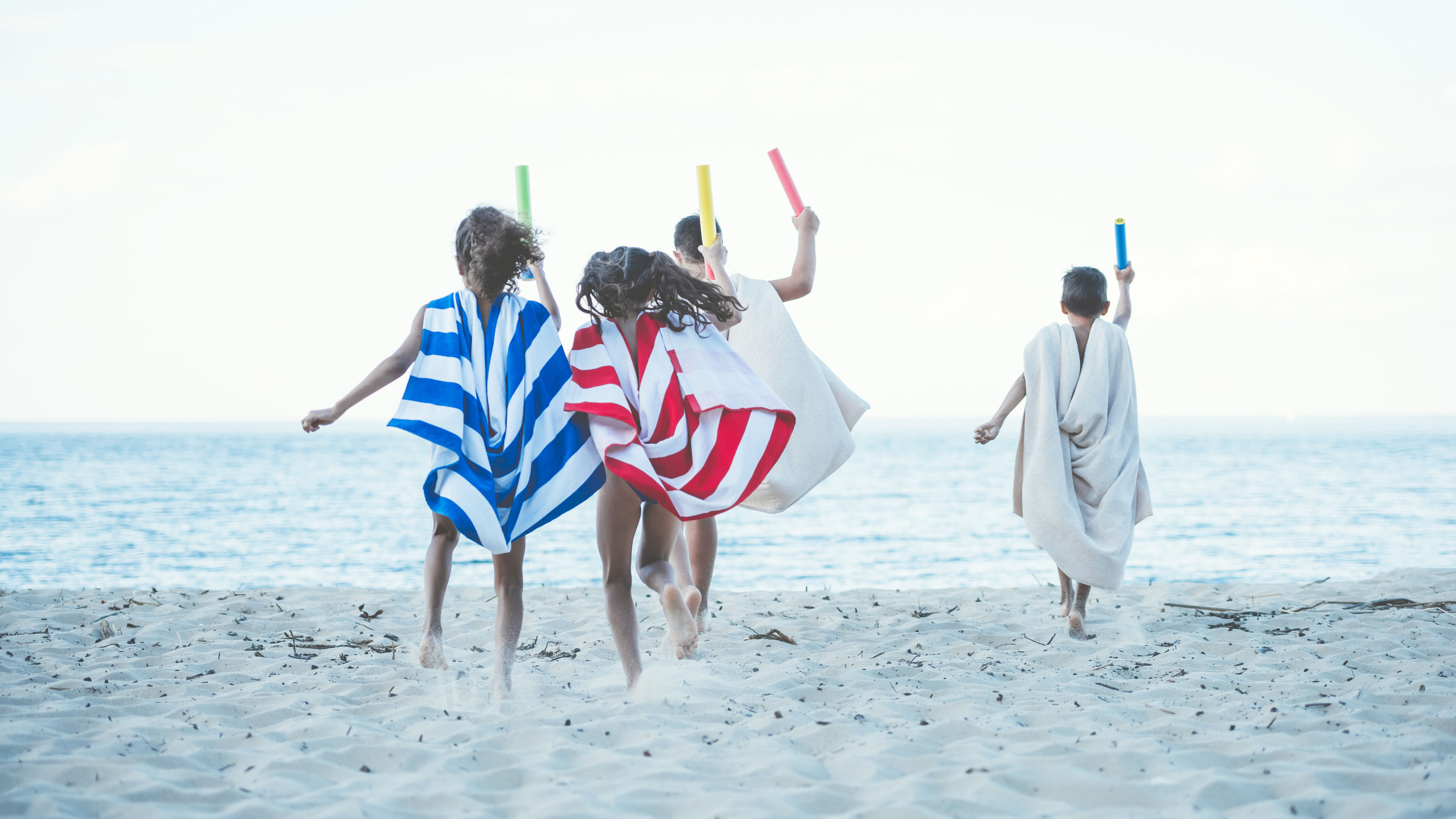 Some people are playing on the beach