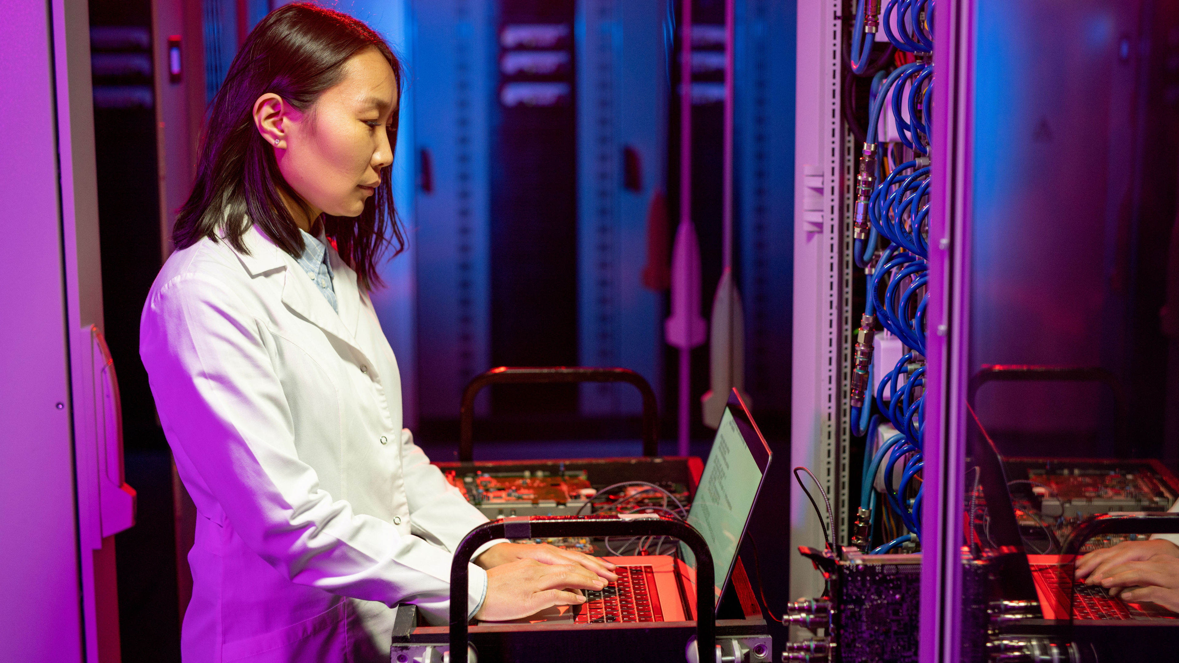 Asian IT specialist performing diagnostic tests 