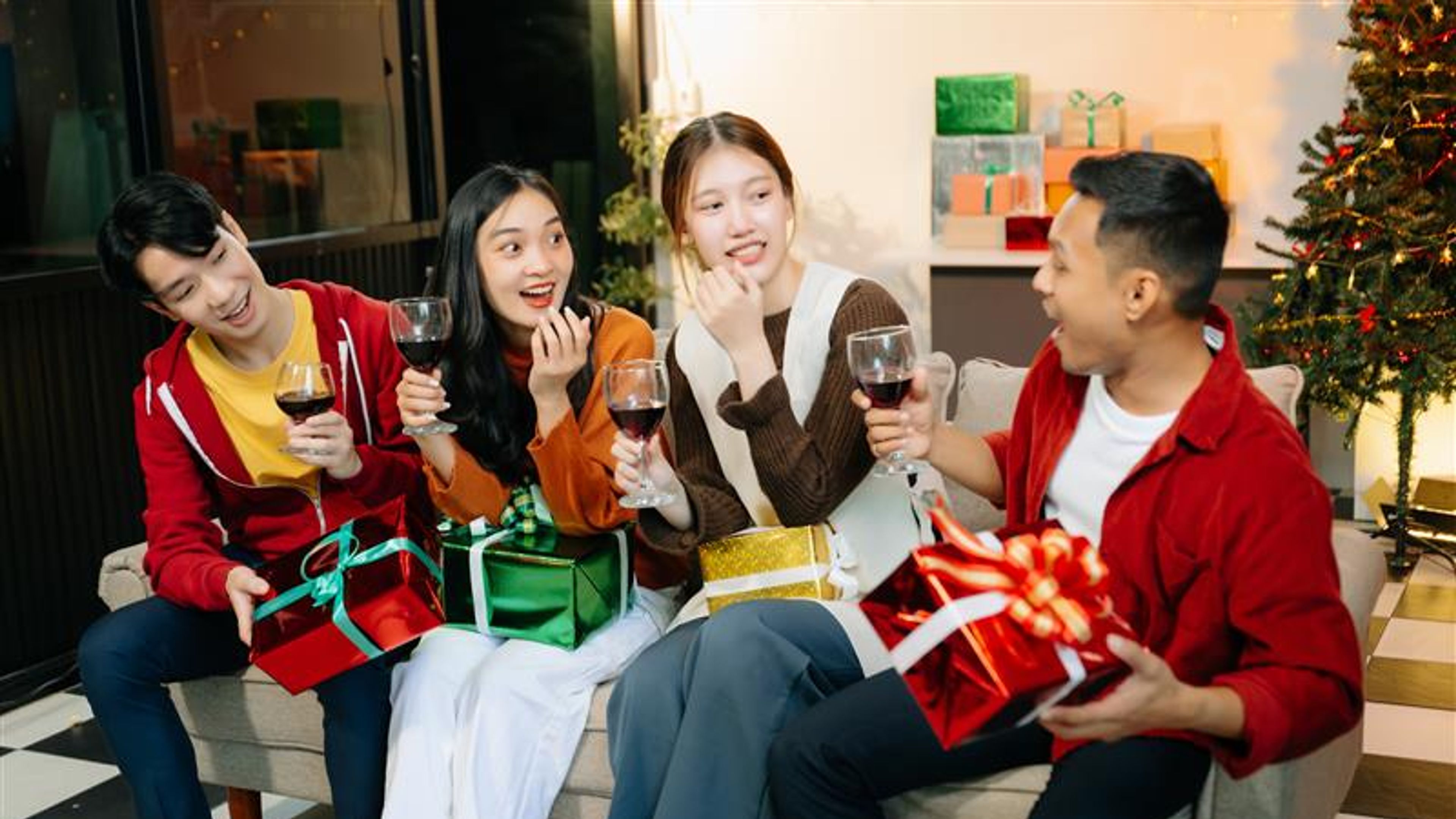 Friends celebrate Christmas with gift exchanges, festive food, and laughtera perfect scene