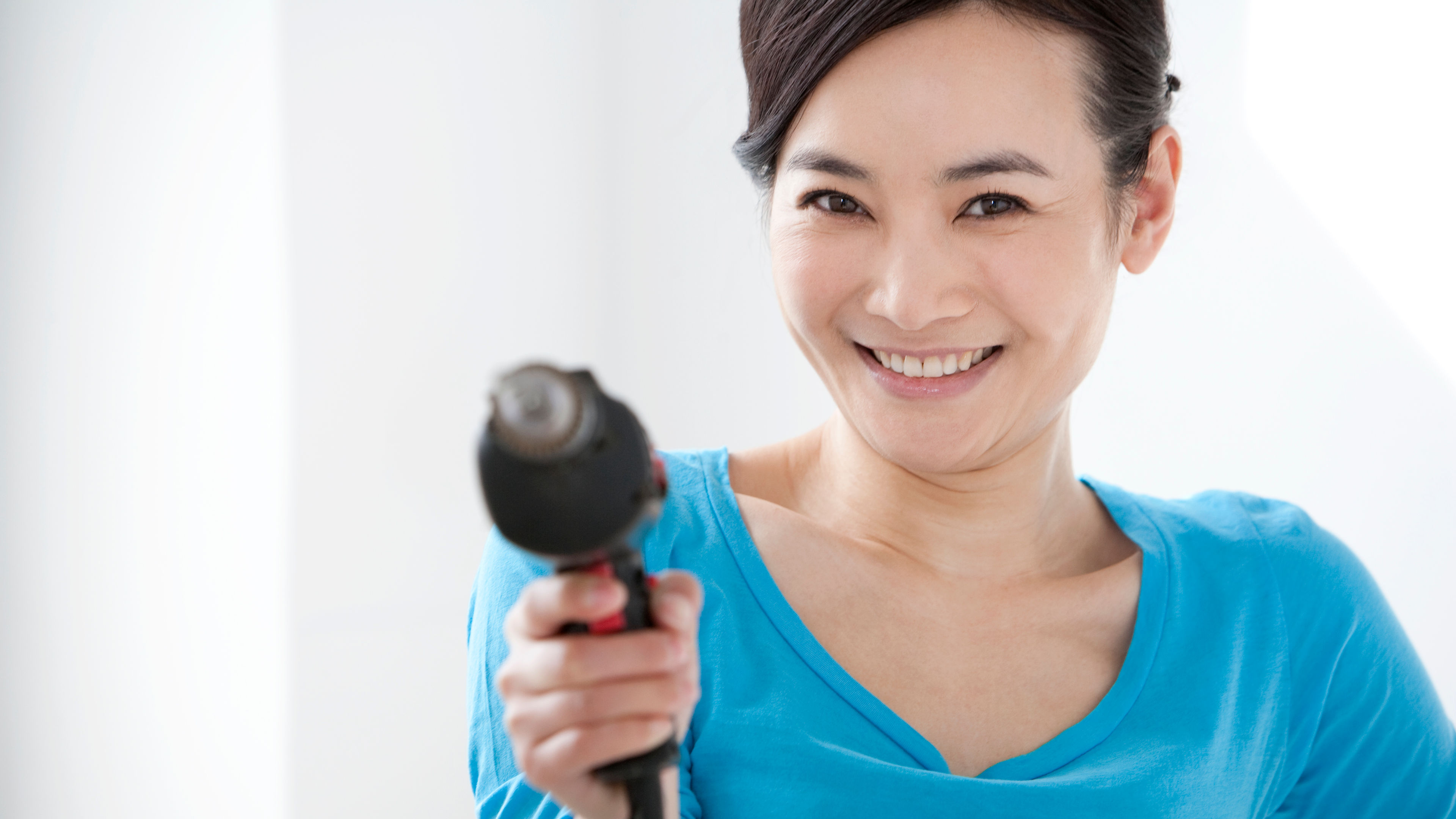 Portrait of happy woman with electronic appliance 