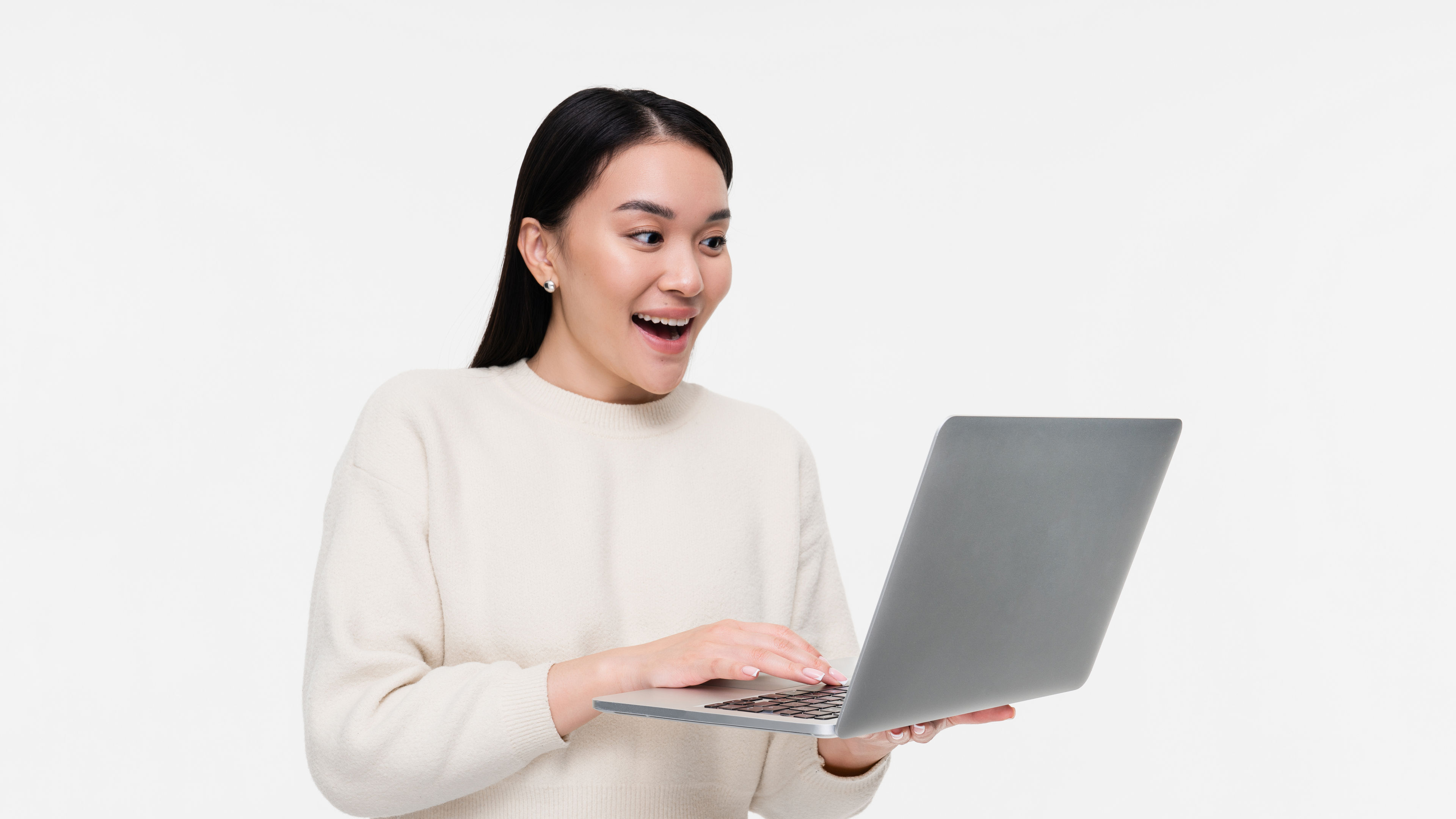 Woman excited seeing laptop 