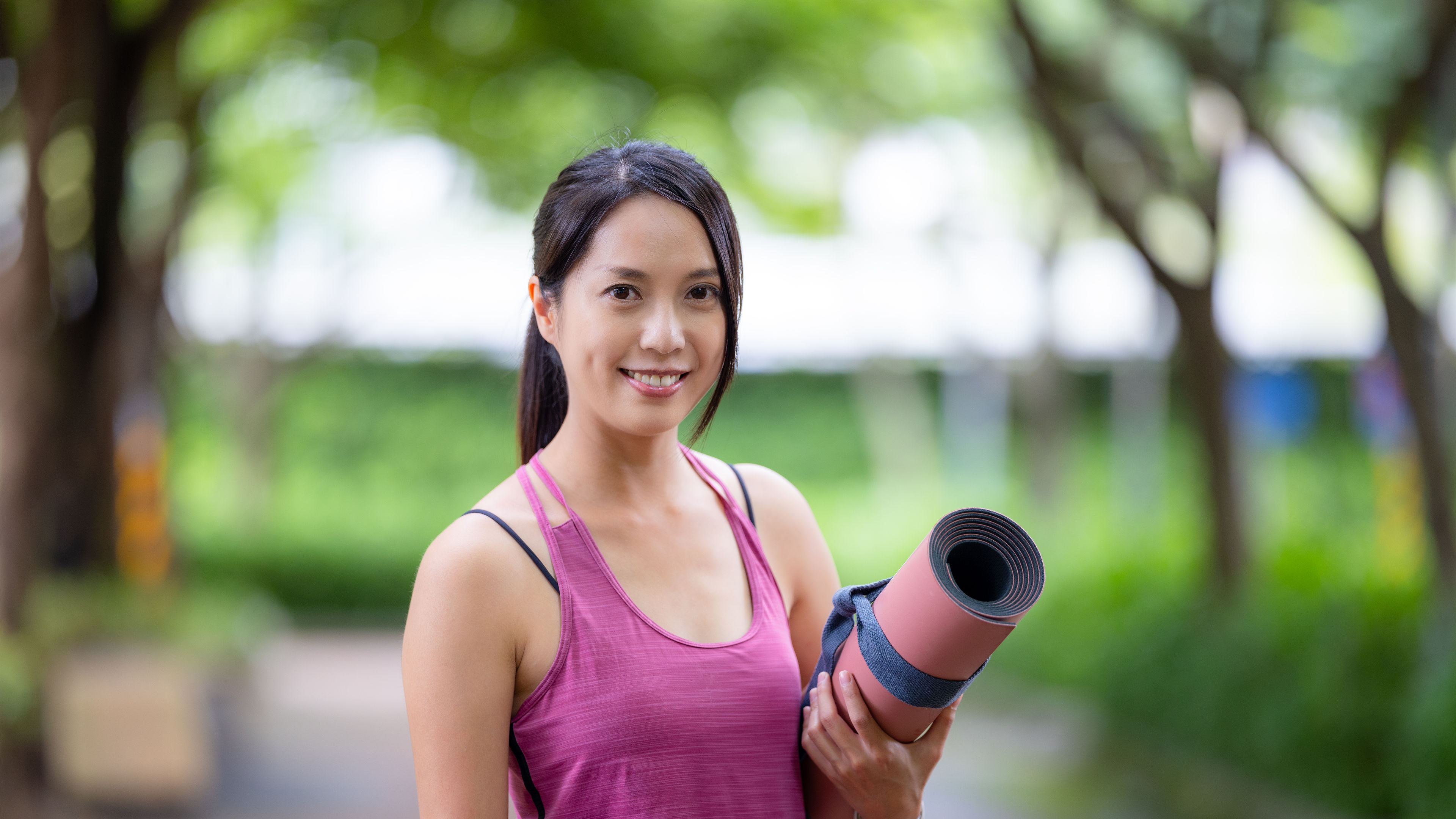 Woman holding yoga mat