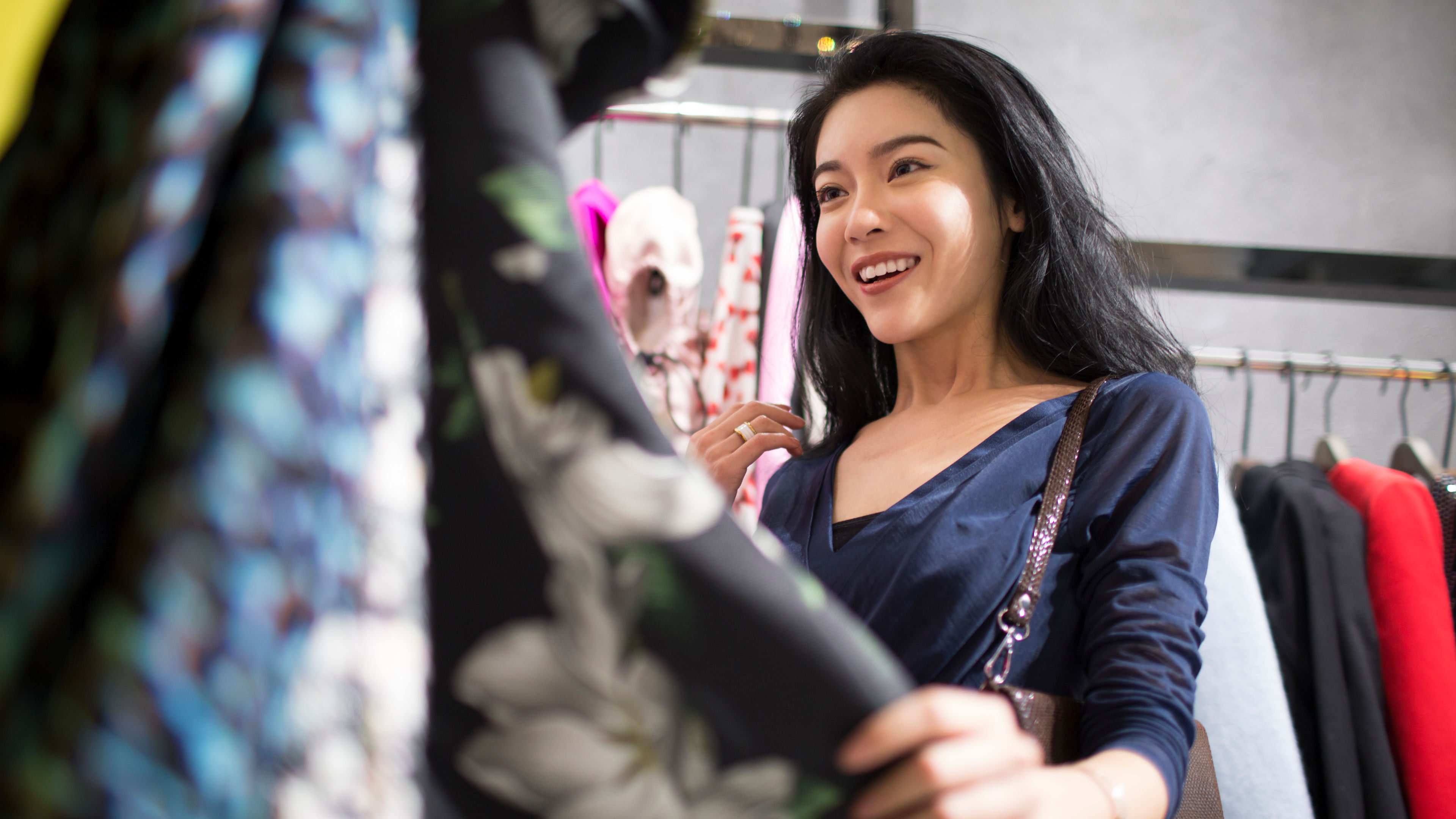 Young woman shopping in clothing store 