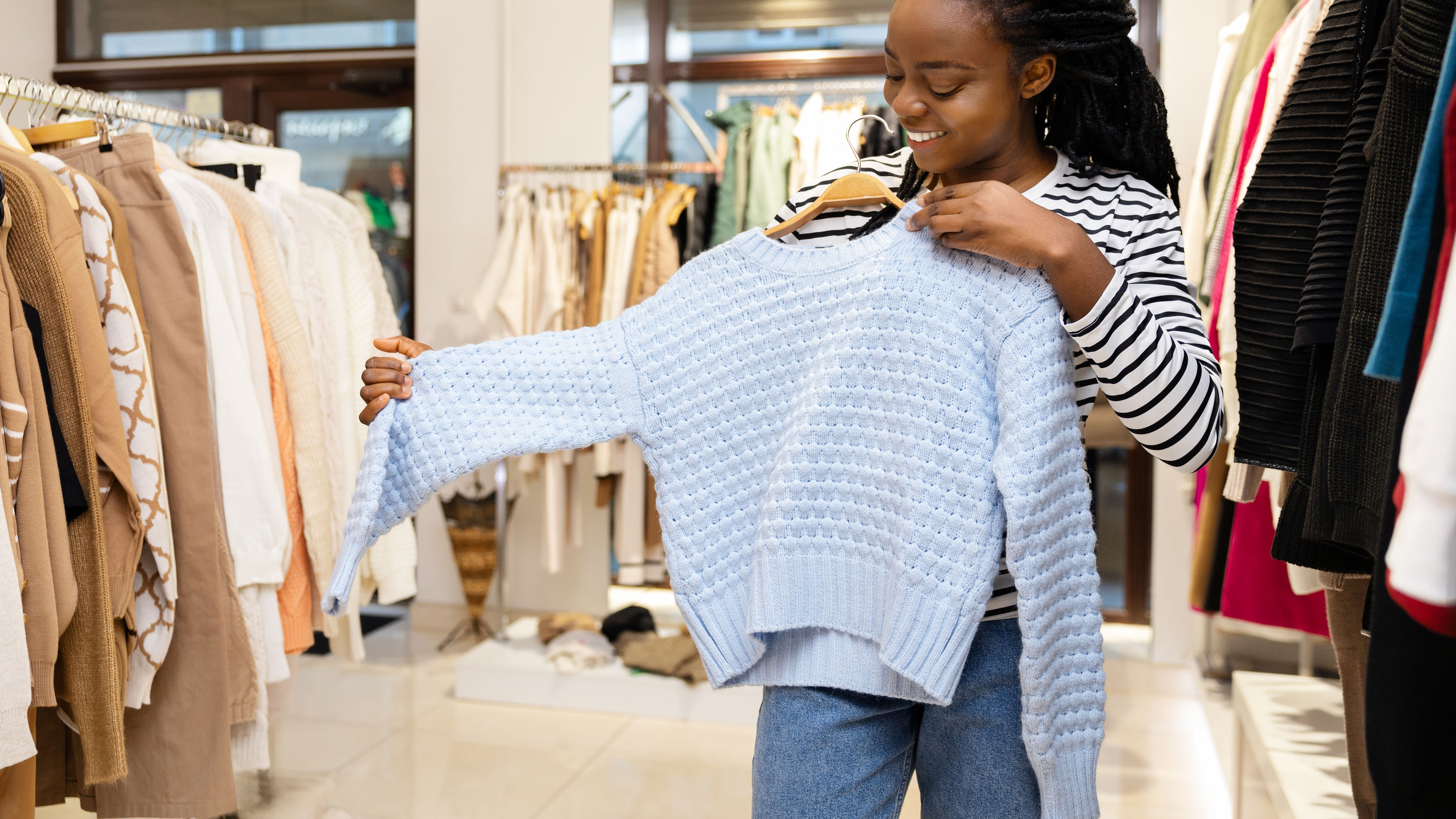 Young woman selecting dresses