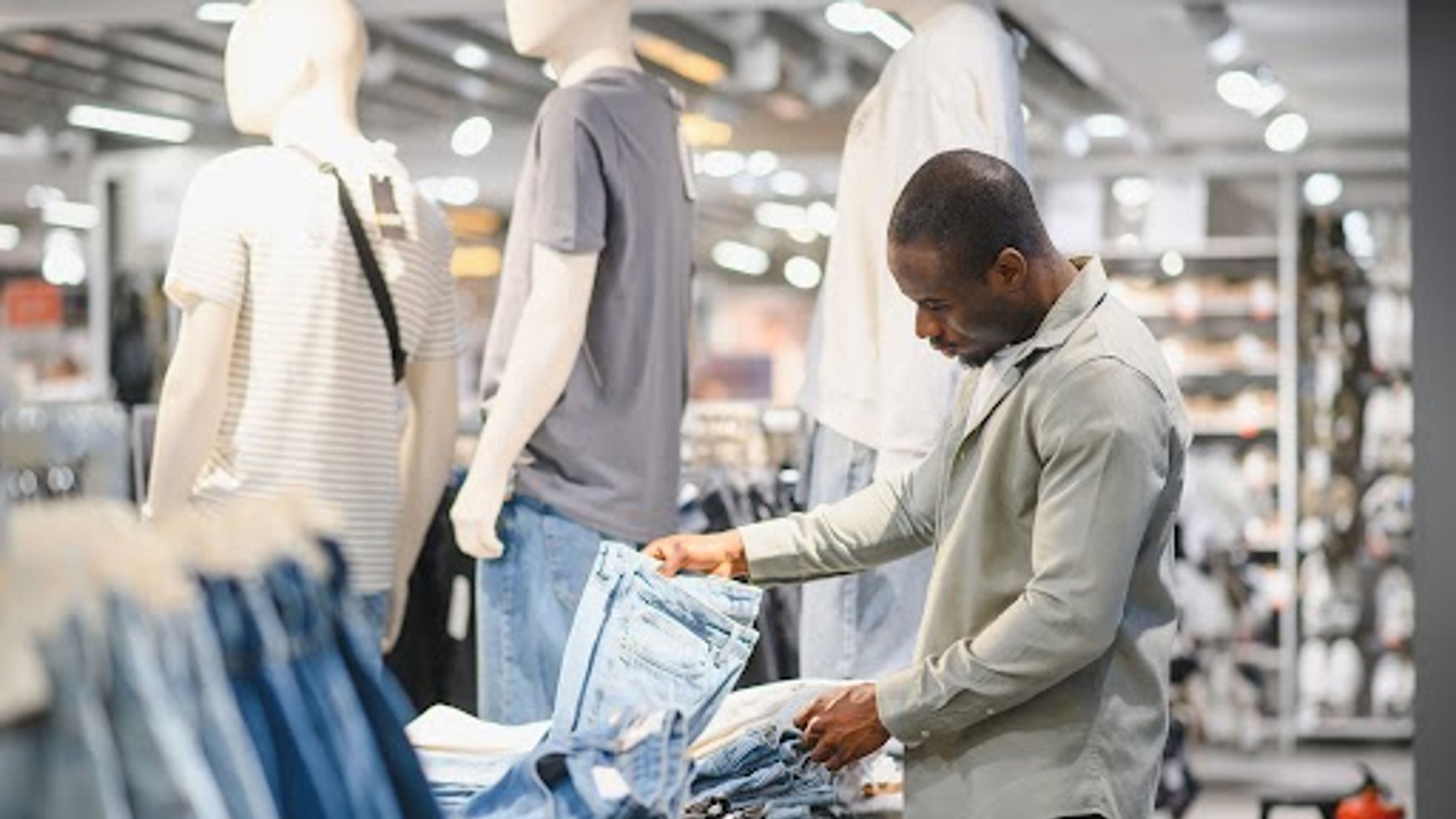 Man choosing jeans 