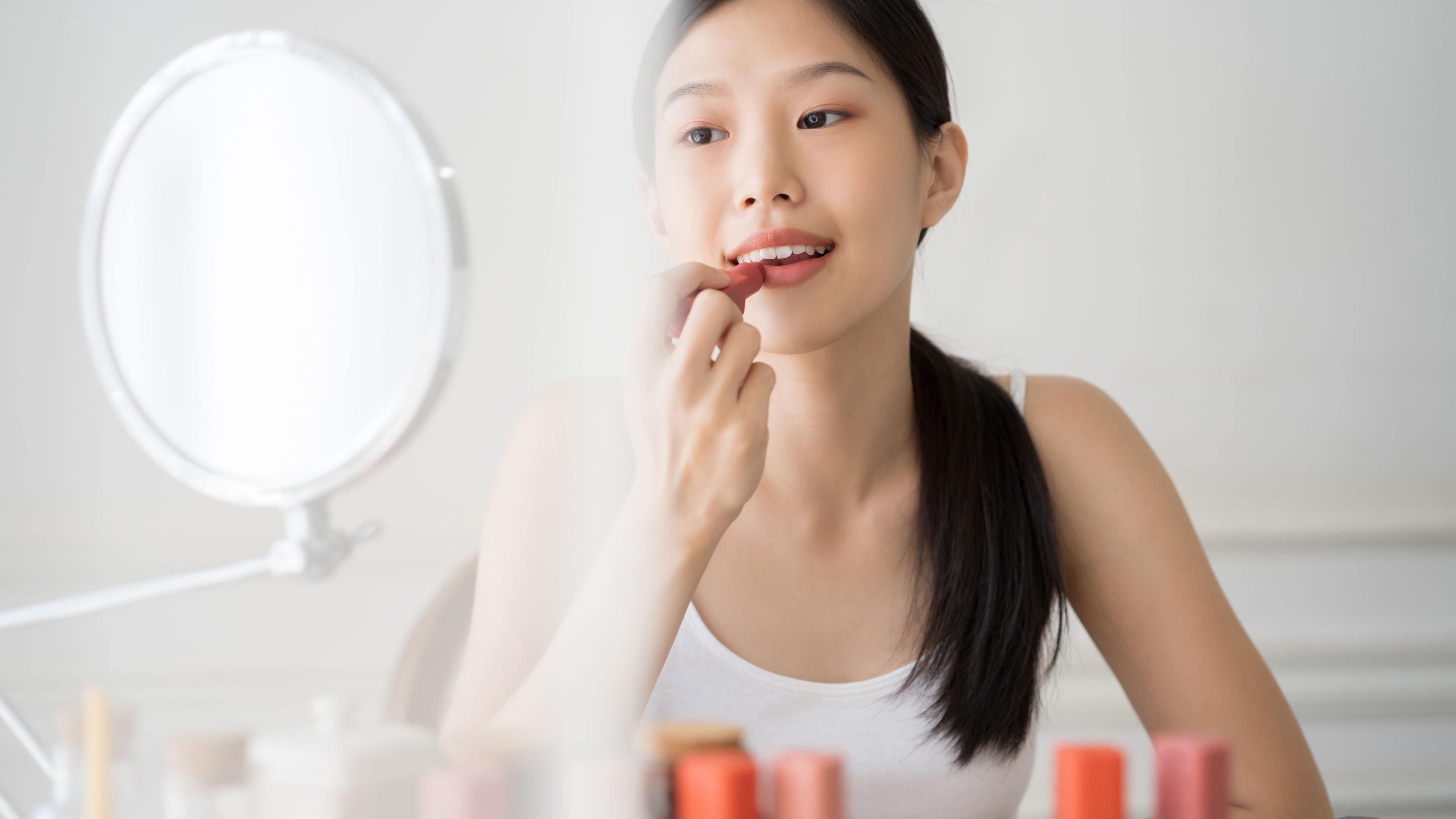 Young girl using makeup products