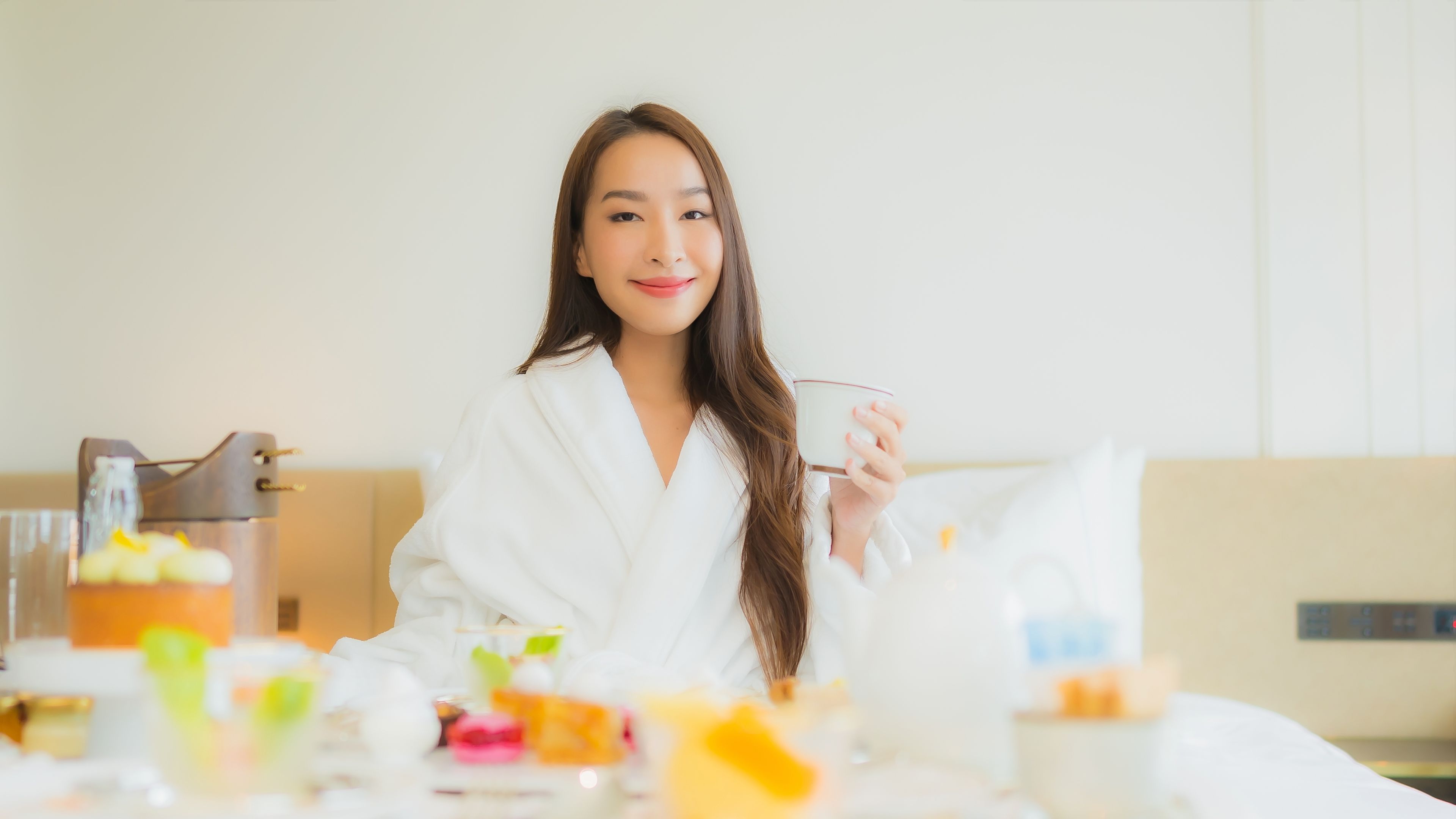 beautiful young asian woman enjoy with breakfast on bed