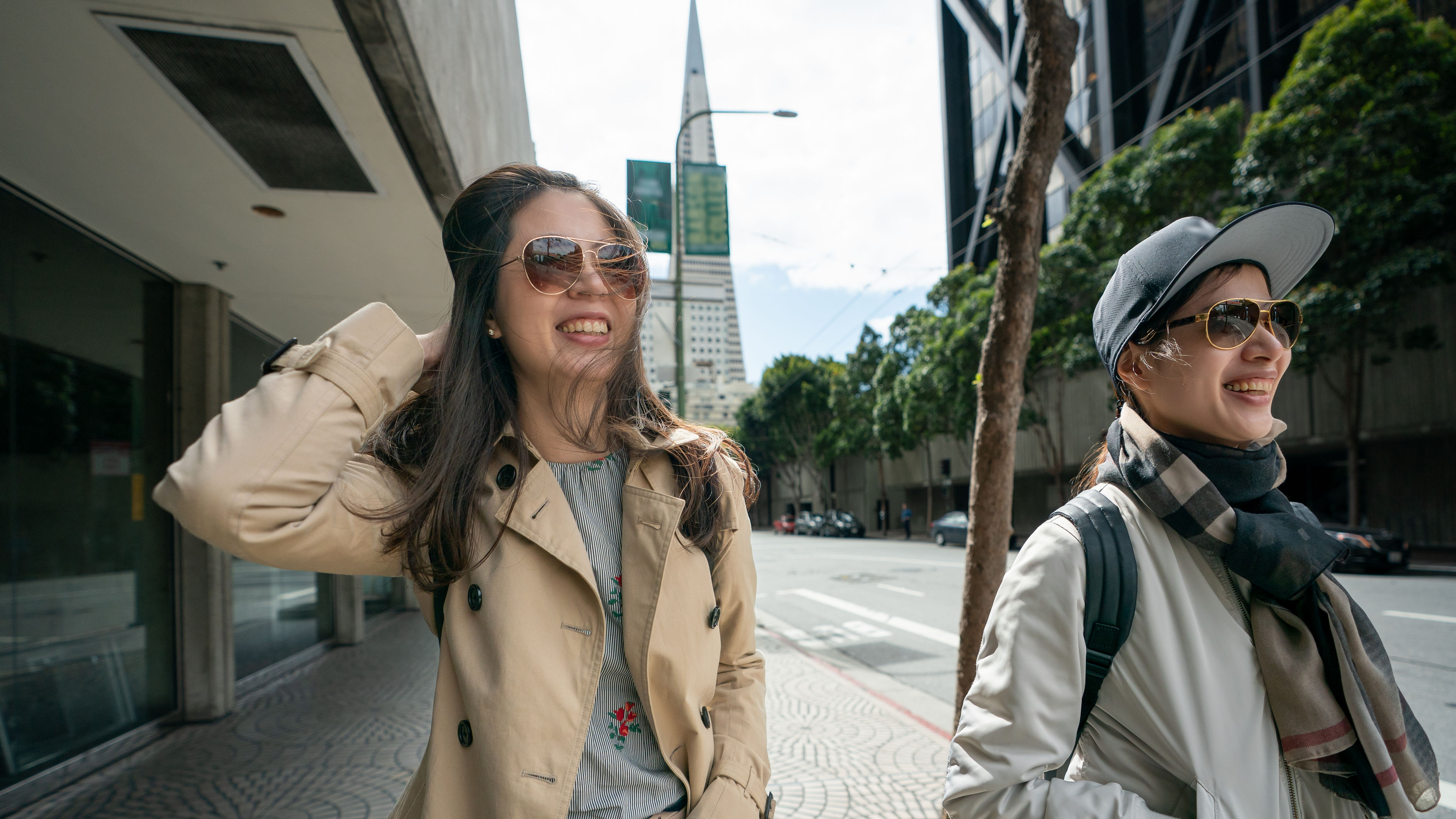 businesswoman walking with colleague on street