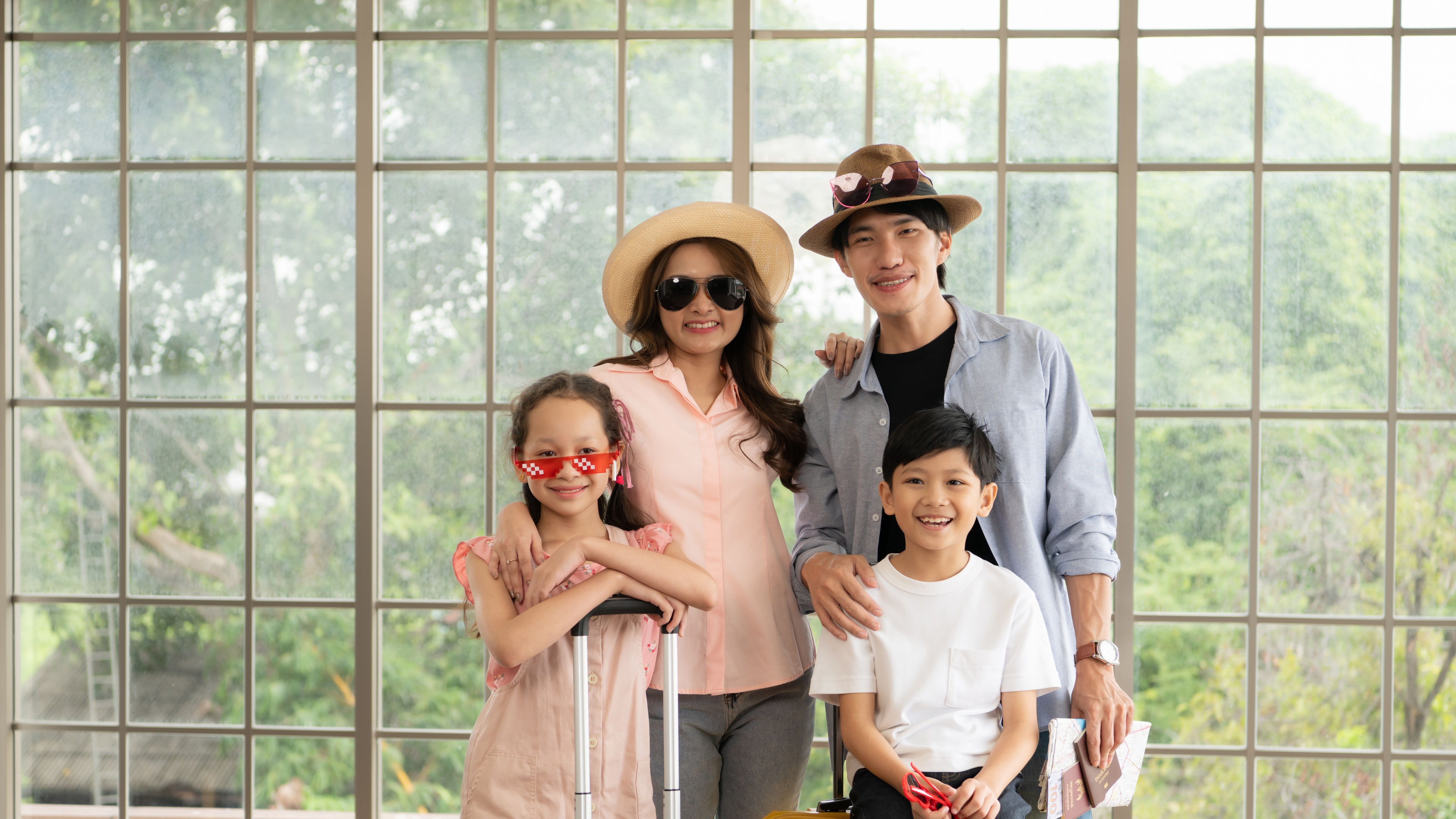 Father, mother, son and daughter packing for a weekend trip and ready to go.