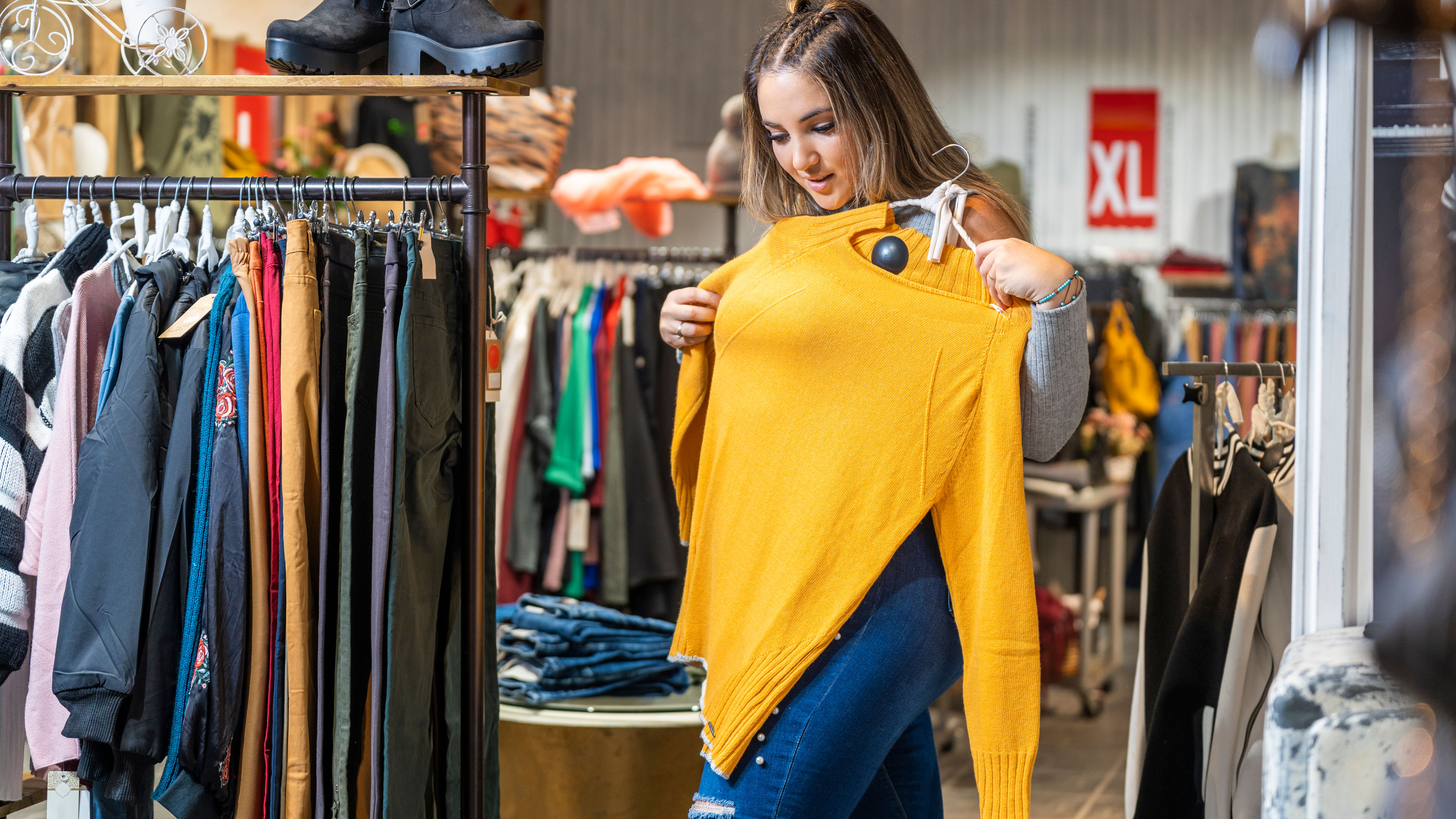 Portrait of an overweight woman trying on some clothes in a clothing store in the plus size section