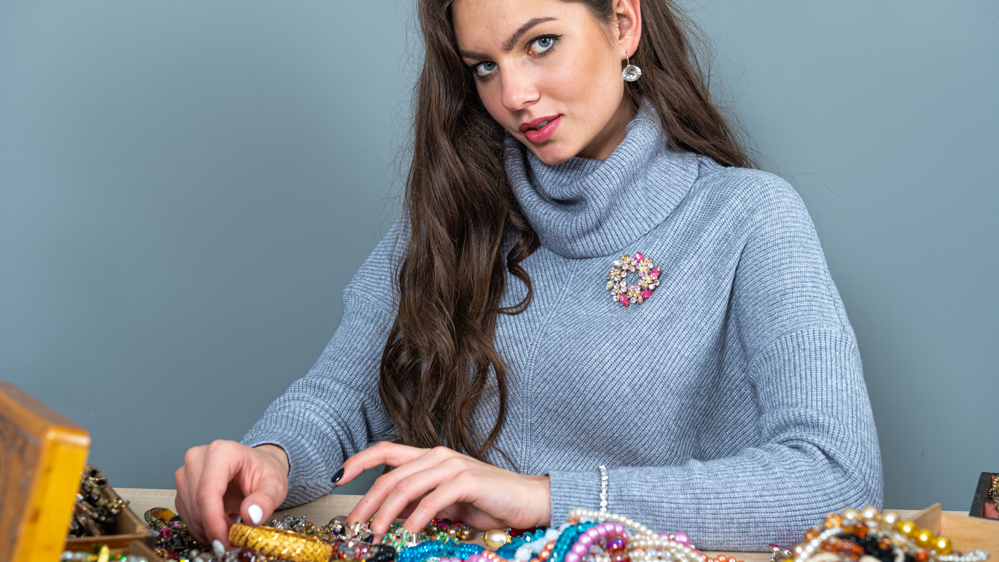 A woman with multicolored floral brooch pinned on it