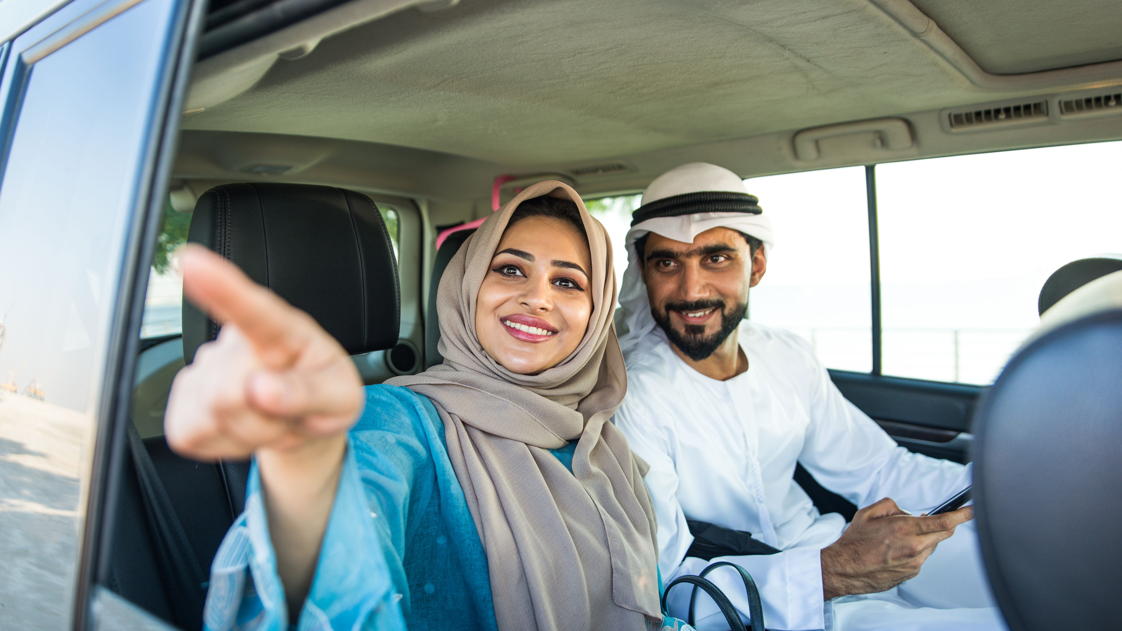 Arabic couple in the car enjoying uae. 