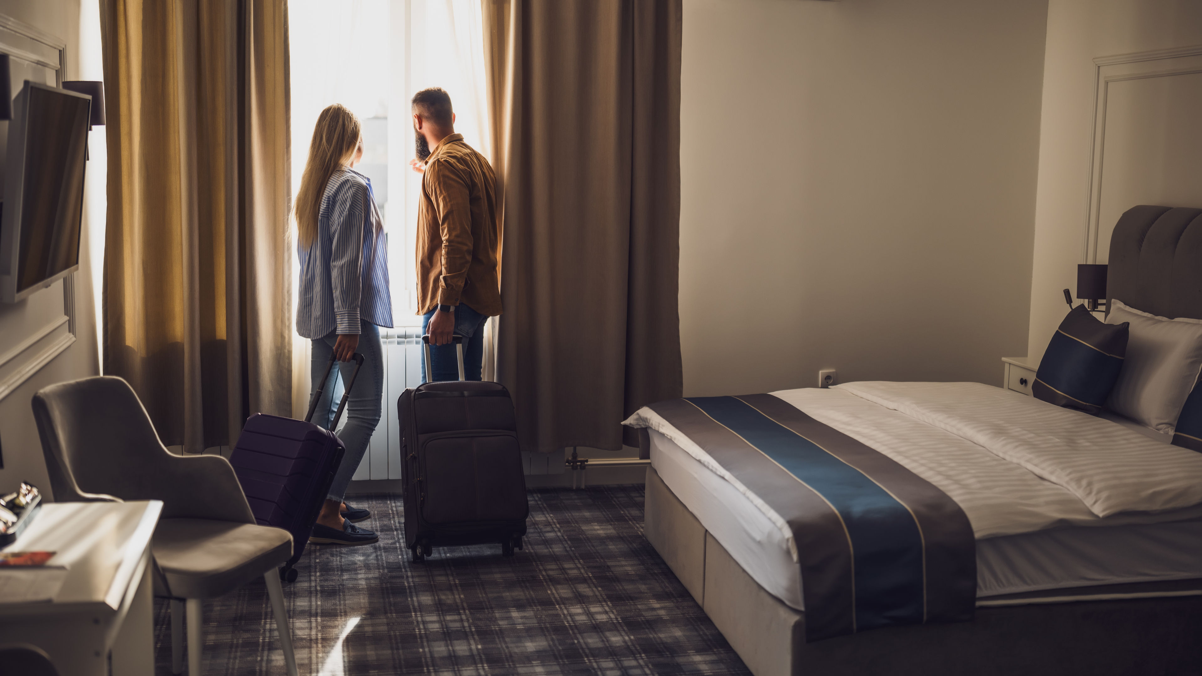 Tourist couples in hotel room
