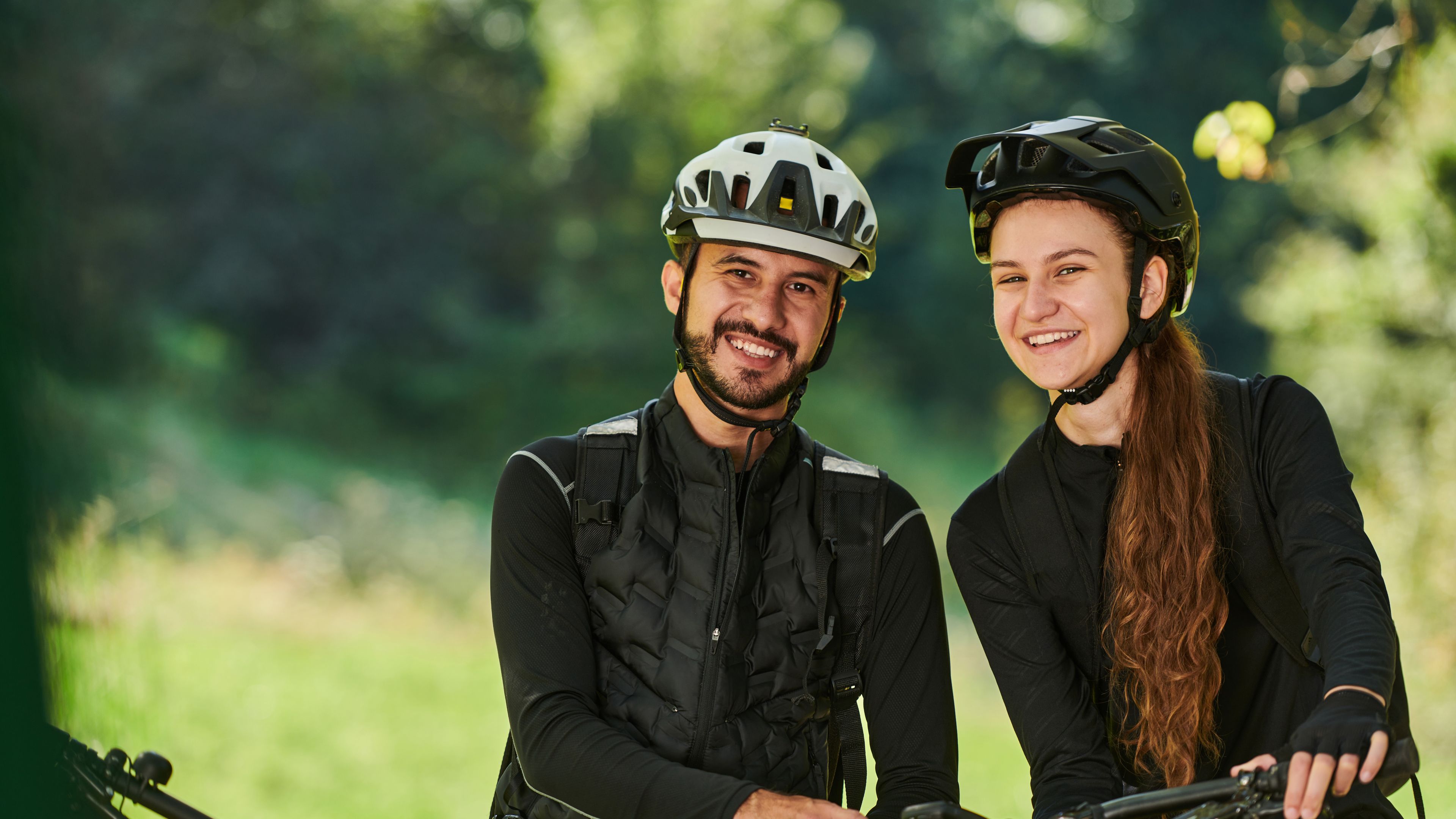 A couple in sportswear and helmet