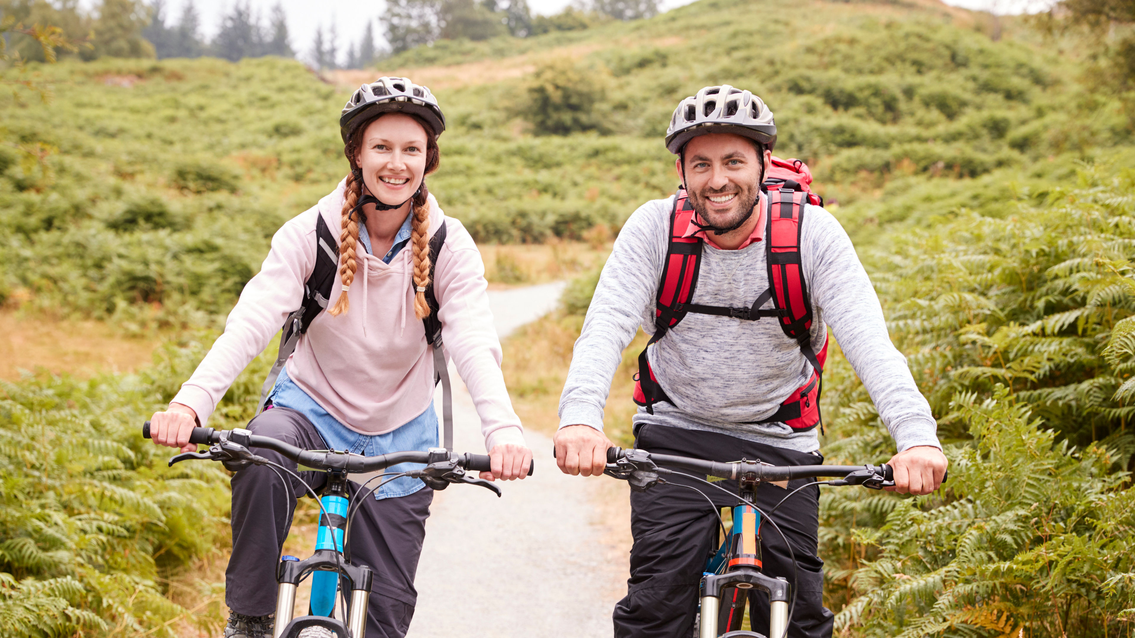 A couple riding on bicycles.