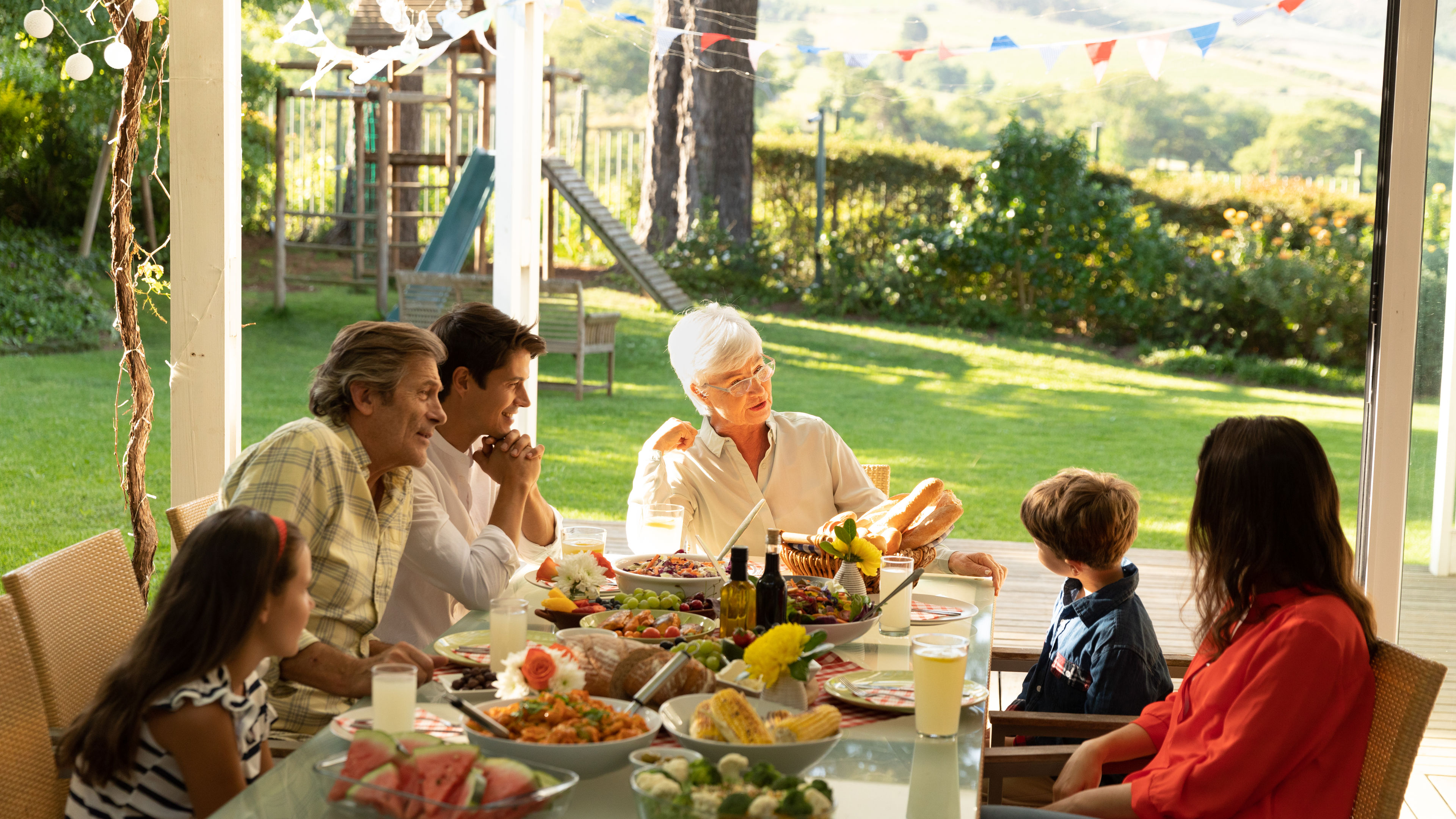 A family enjoying a sunny Sunday lunch.
