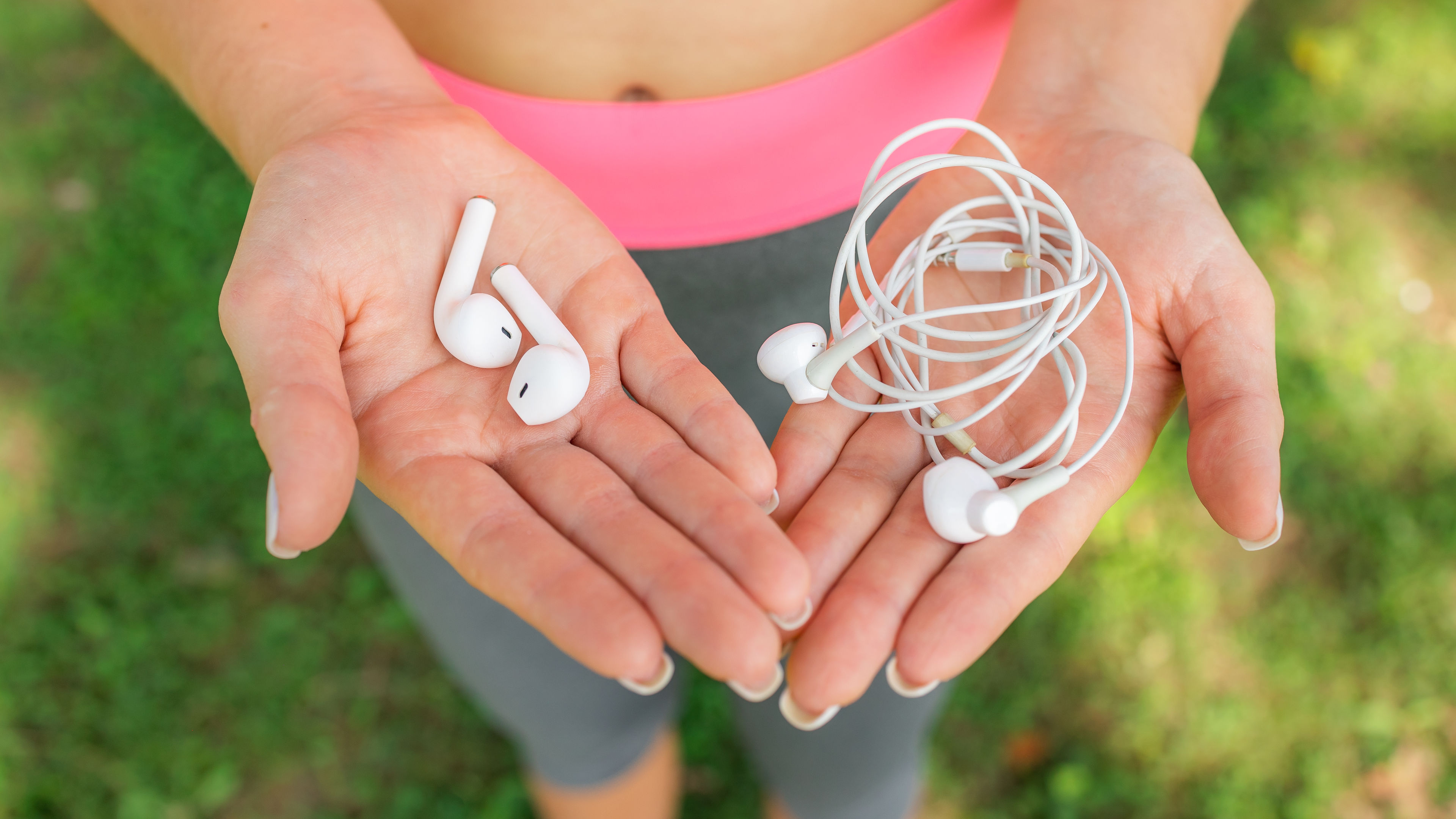 A white headset in a hand of a person
