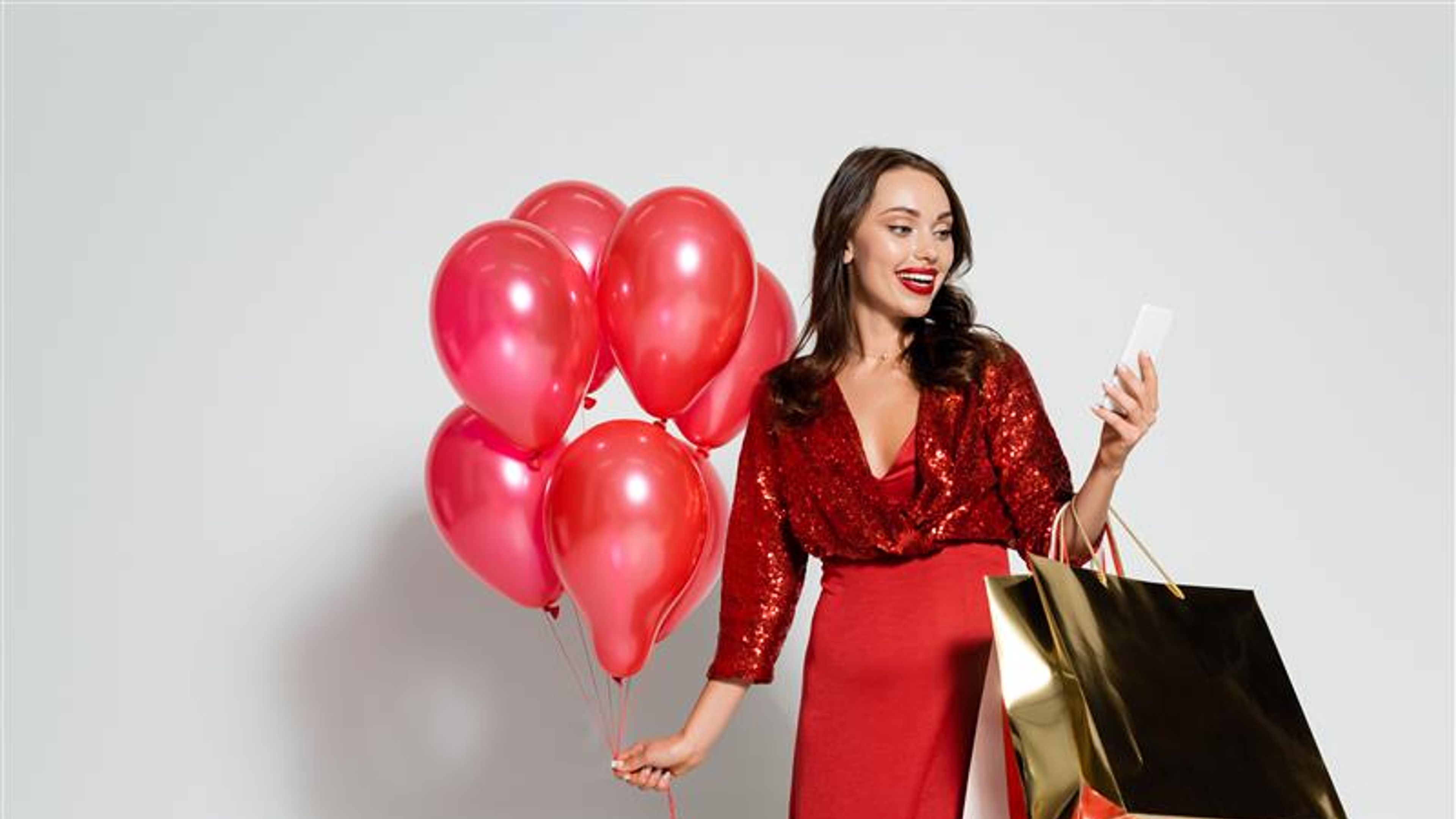 Brunette woman shopping in red dress 